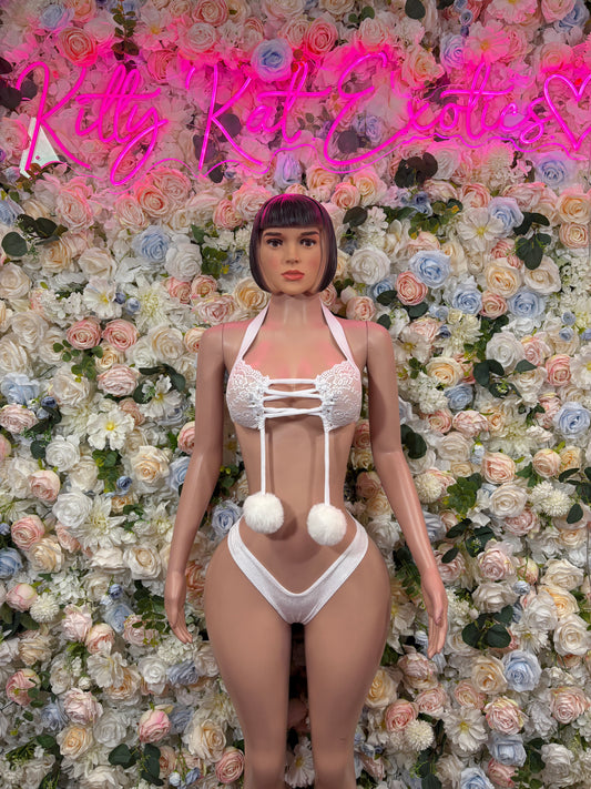 White strappy two-piece rave bikini with thong bottom and pom-pom accents