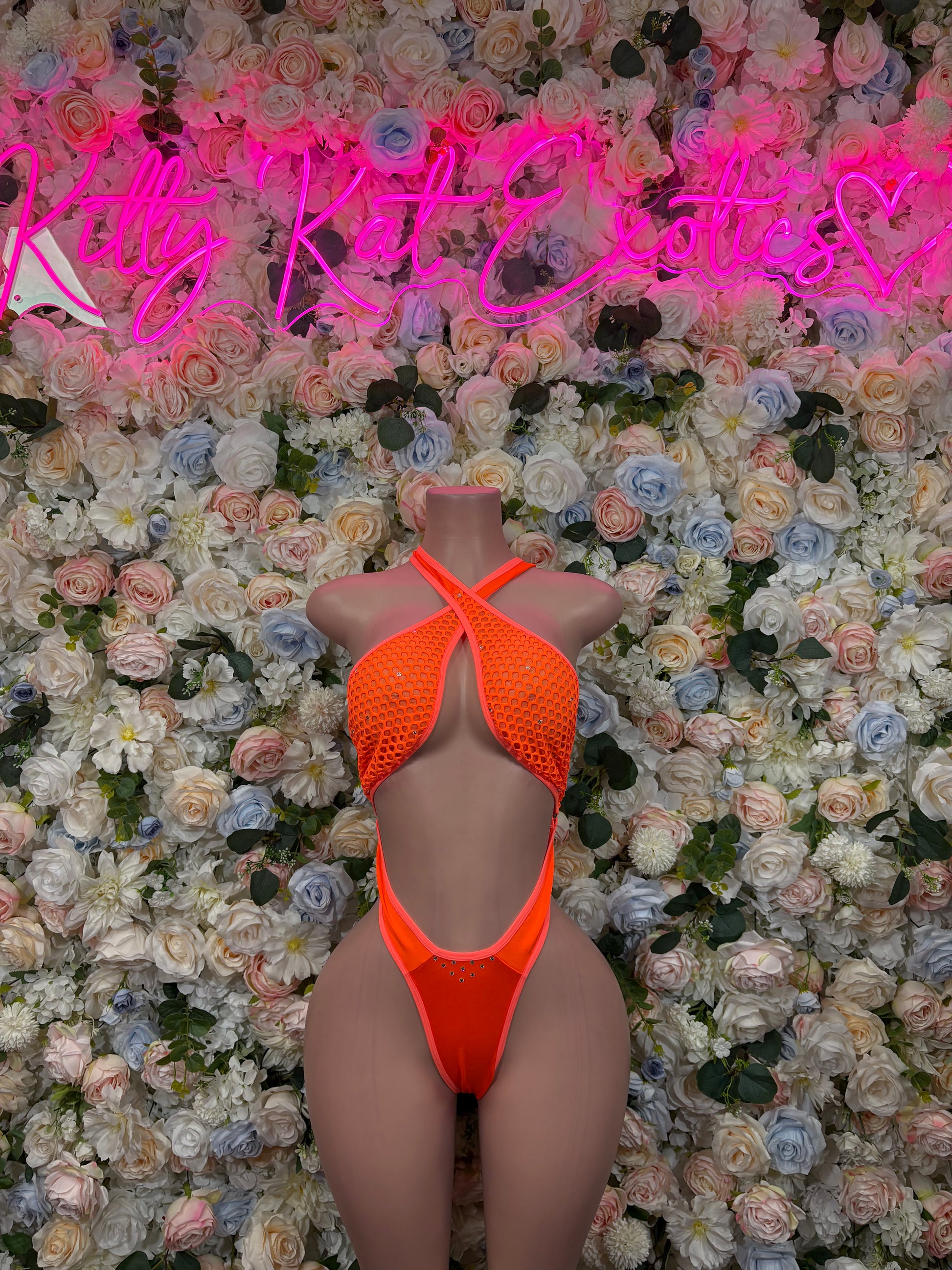 Orange halter one-piece bodysuit with open back and strappy underbust cutouts