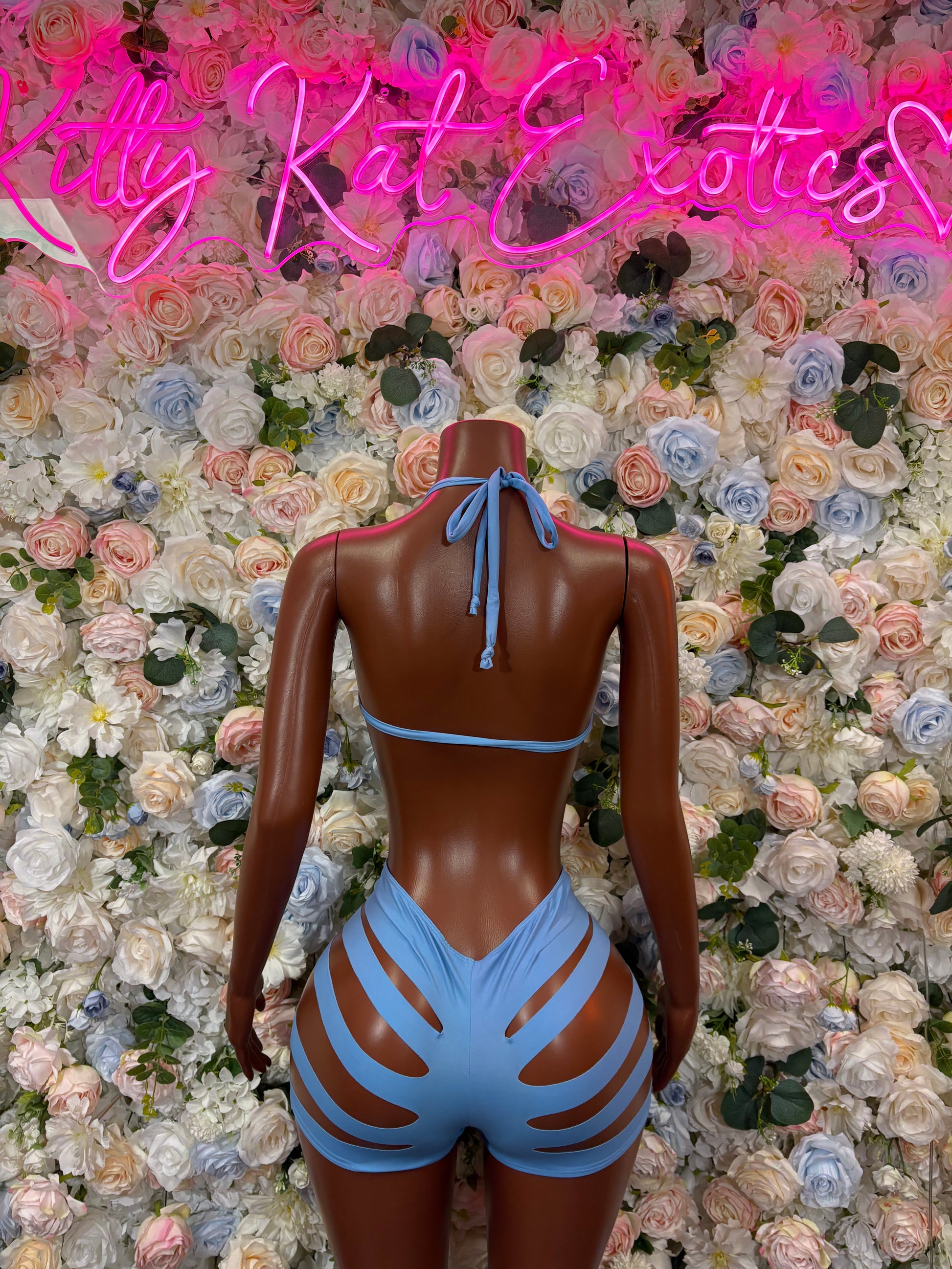Blue two-piece festival outfit, back view: tied halter top and striped high-waist shorts