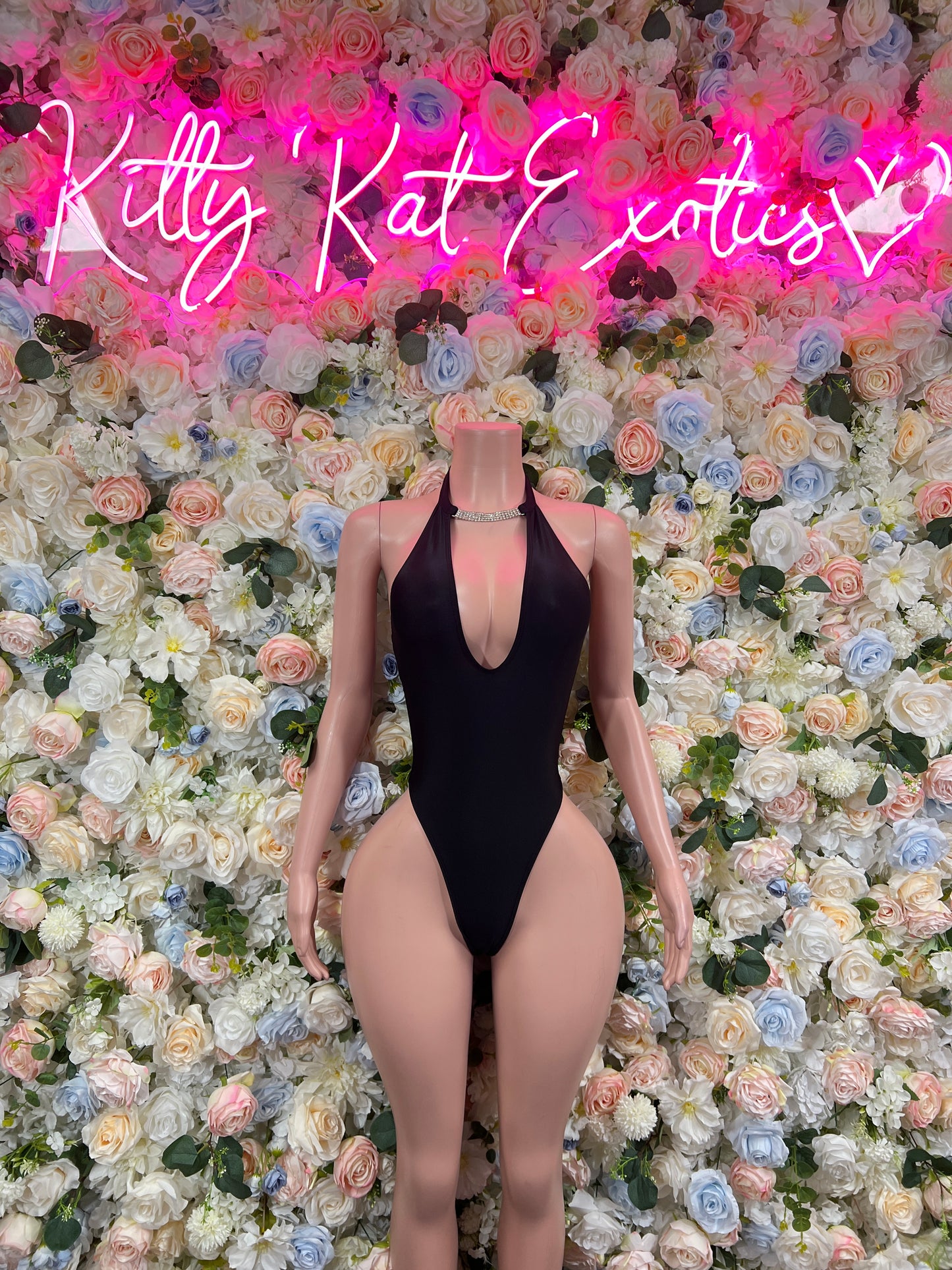 Black one-piece bodysuit with halter neck and deep V front