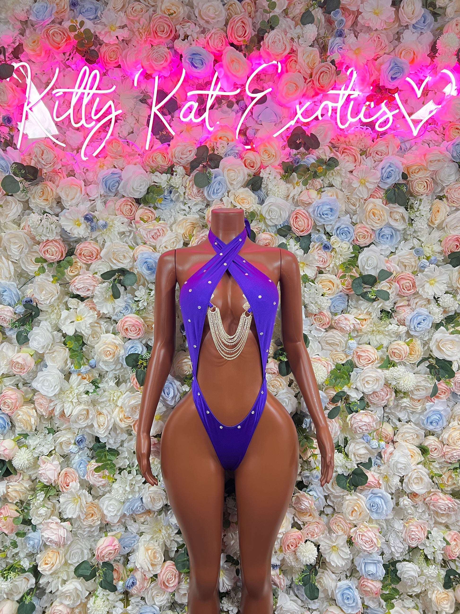 Purple halter one-piece bodysuit with chest cutout and chain fringe detail