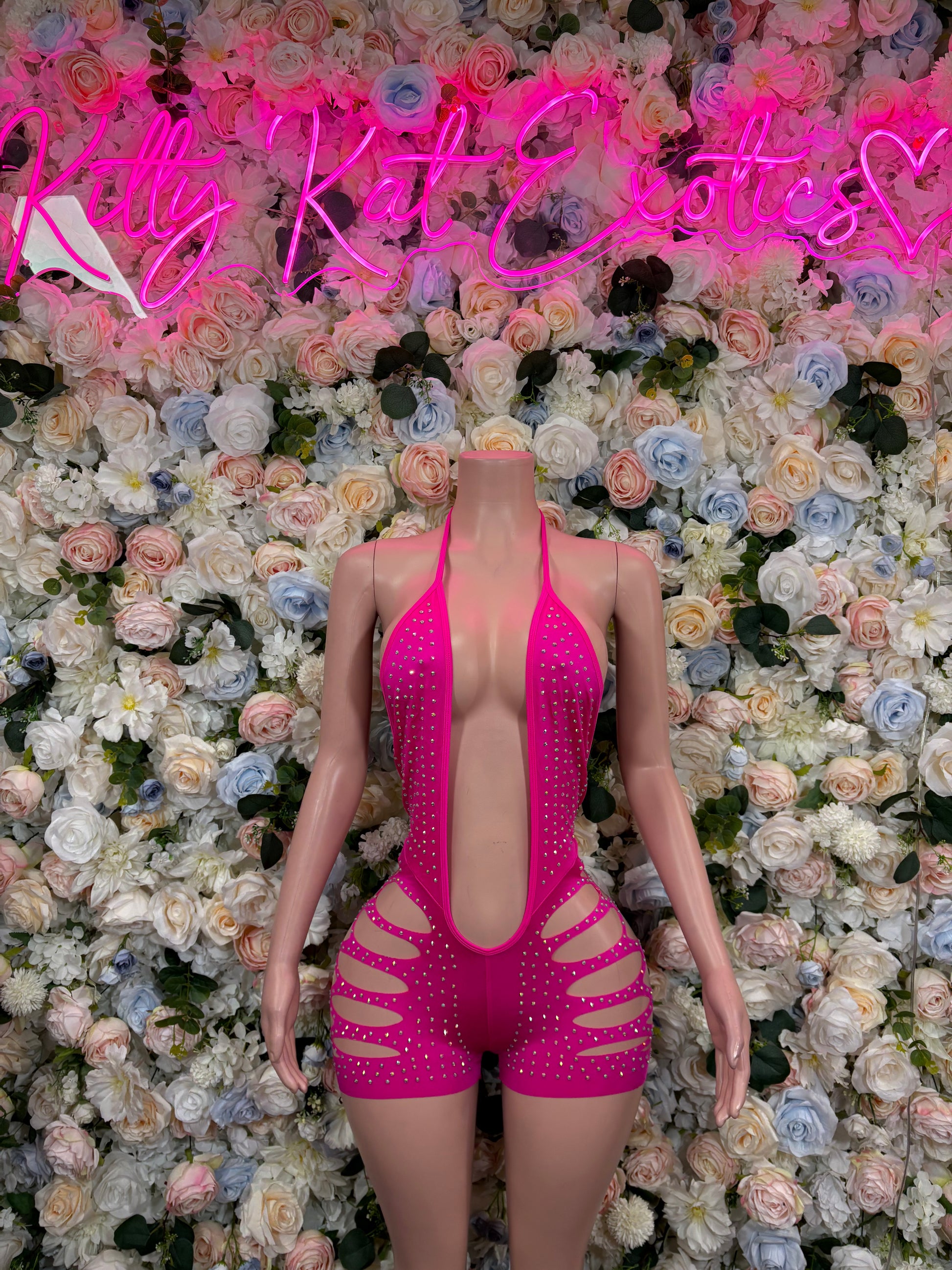 Pink rhinestone bodysuit with open back and rhinestone straps, short cut