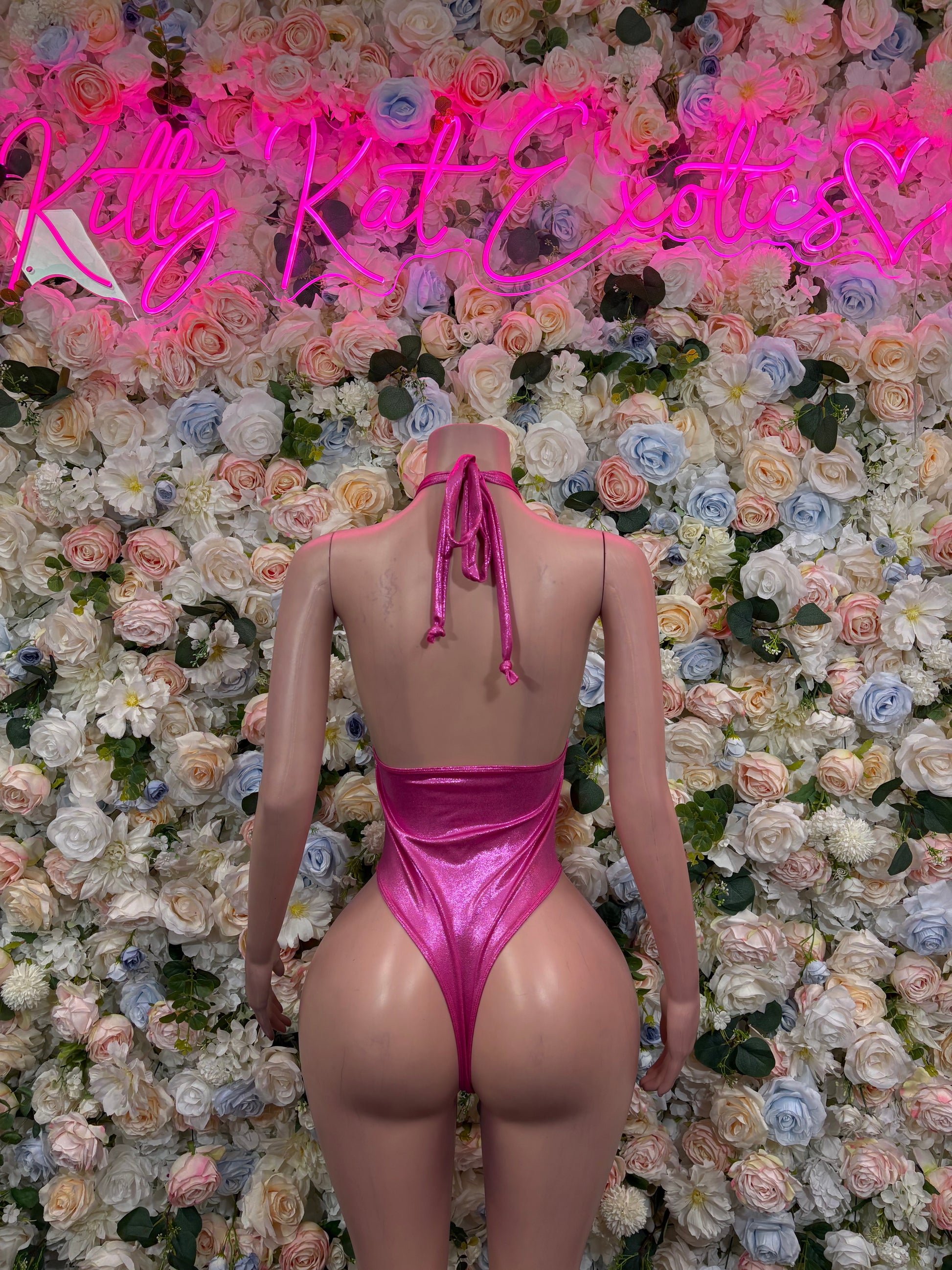 Pink metallic one-piece bodysuit, back view with halter tie and crisscross straps