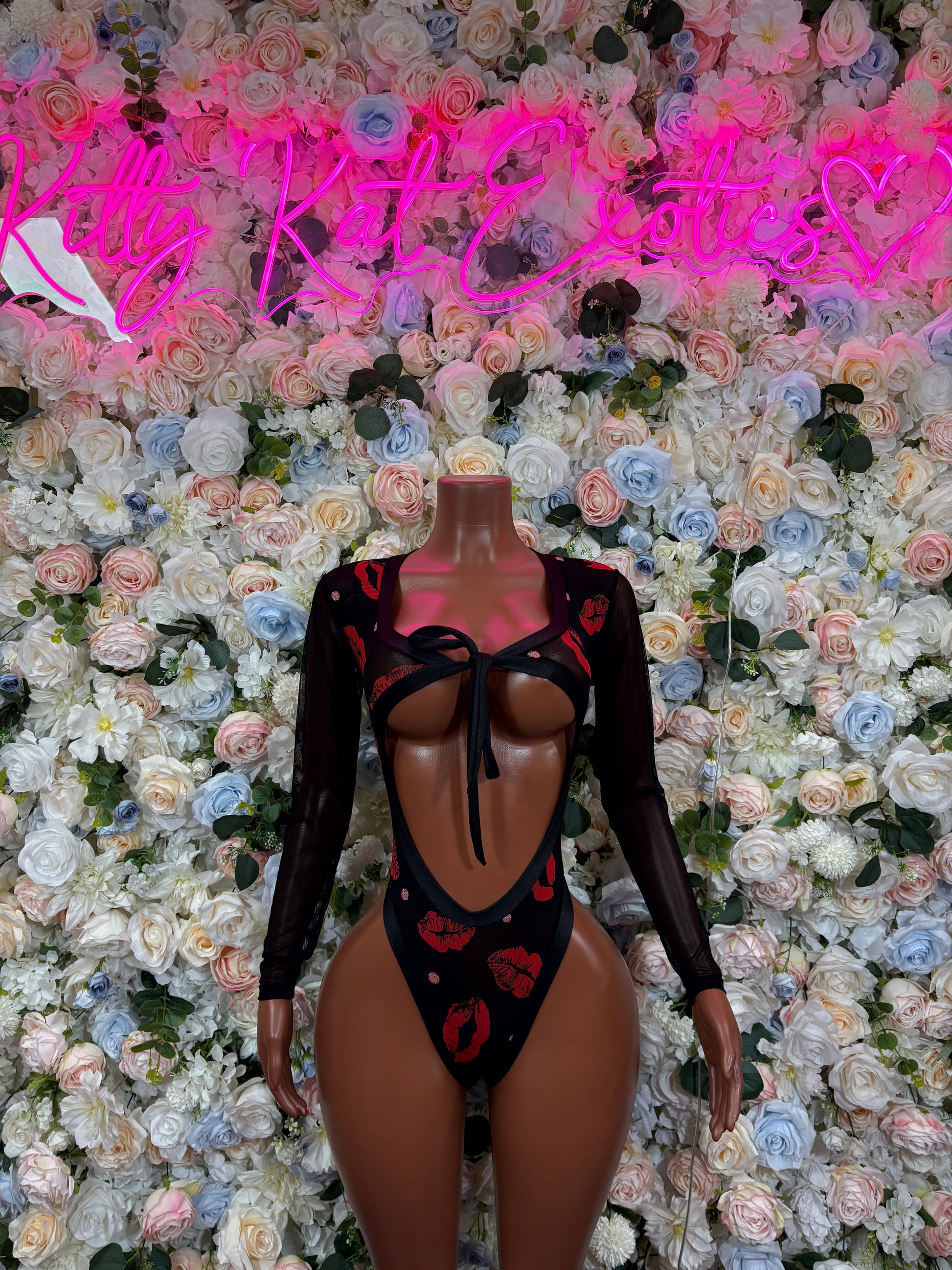 Black sheer long-sleeve bodysuit with red kiss heart print and front cutout