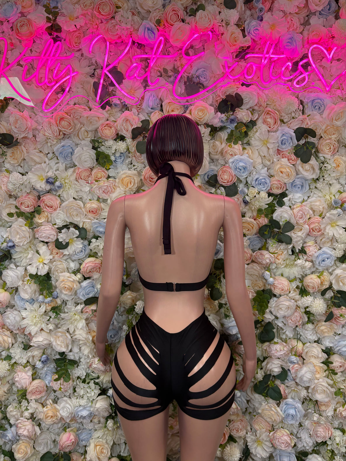 Black backless strappy bodysuit with halter neck and thigh cutouts