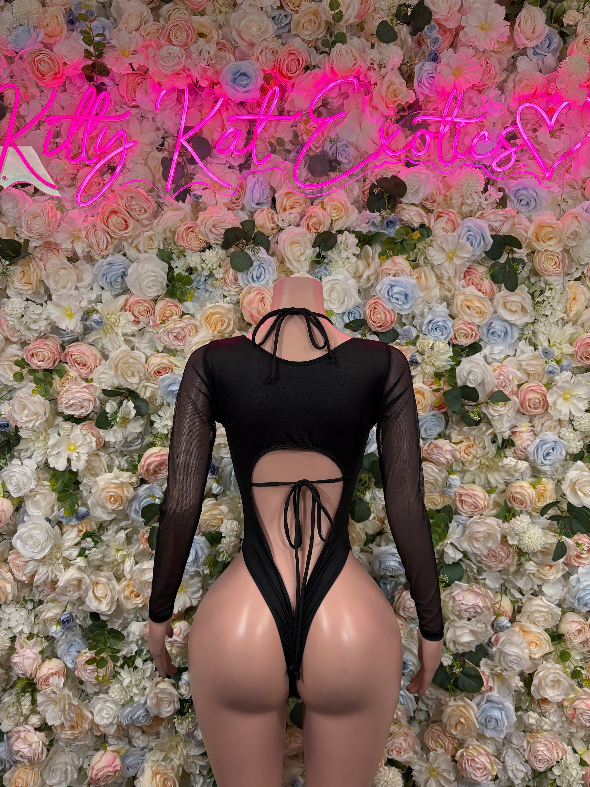 Green cheetah bodysuit with black sheer long sleeves, open back and lace ties