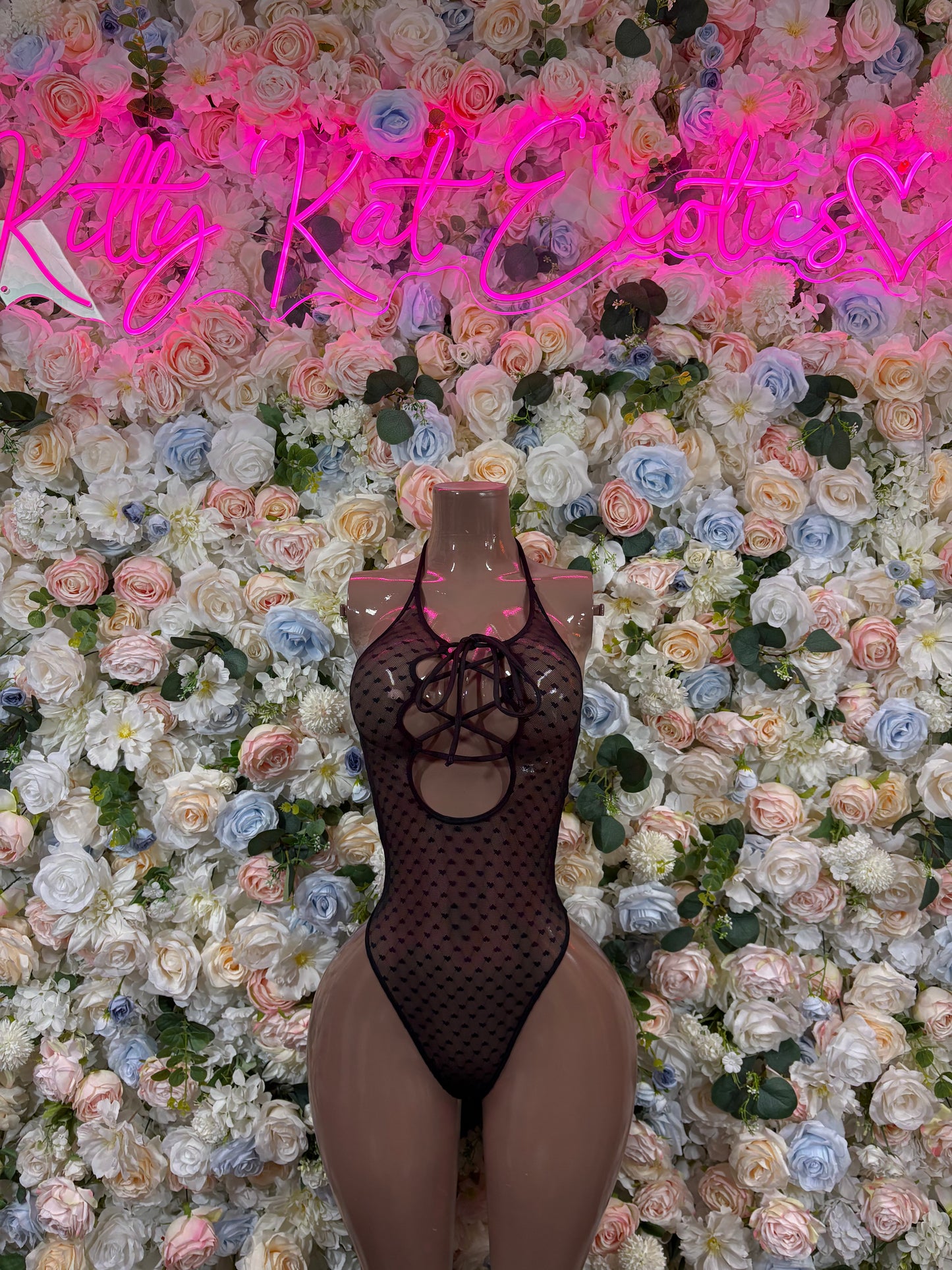 Black mesh heart bodysuit with long sleeves and lace-up front cutout