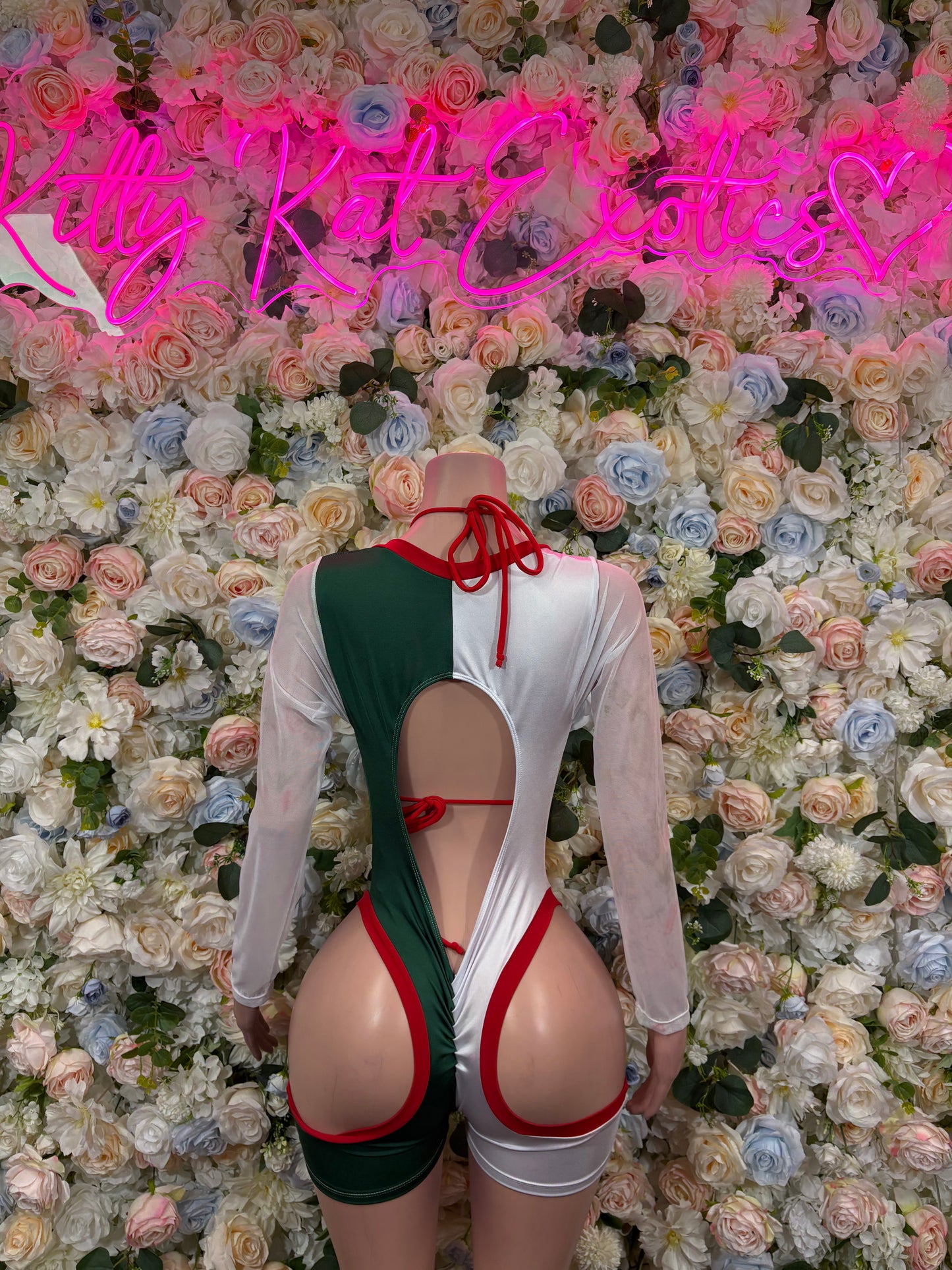 Women’s bodysuit with green-and-white back, red cutout straps, and long sheer sleeves
