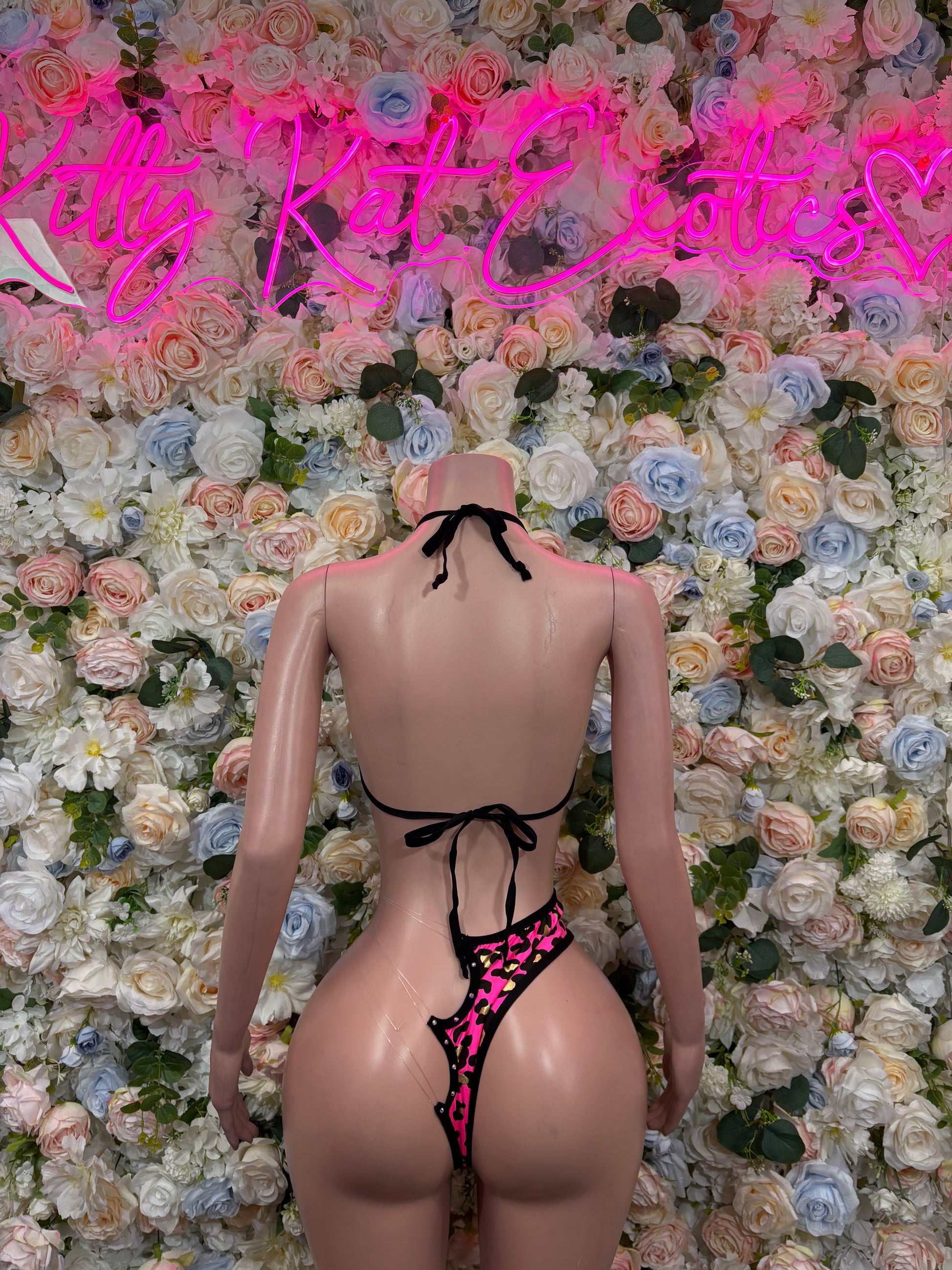 Hot pink cheetah-print bikini lingerie set with black trim, back view