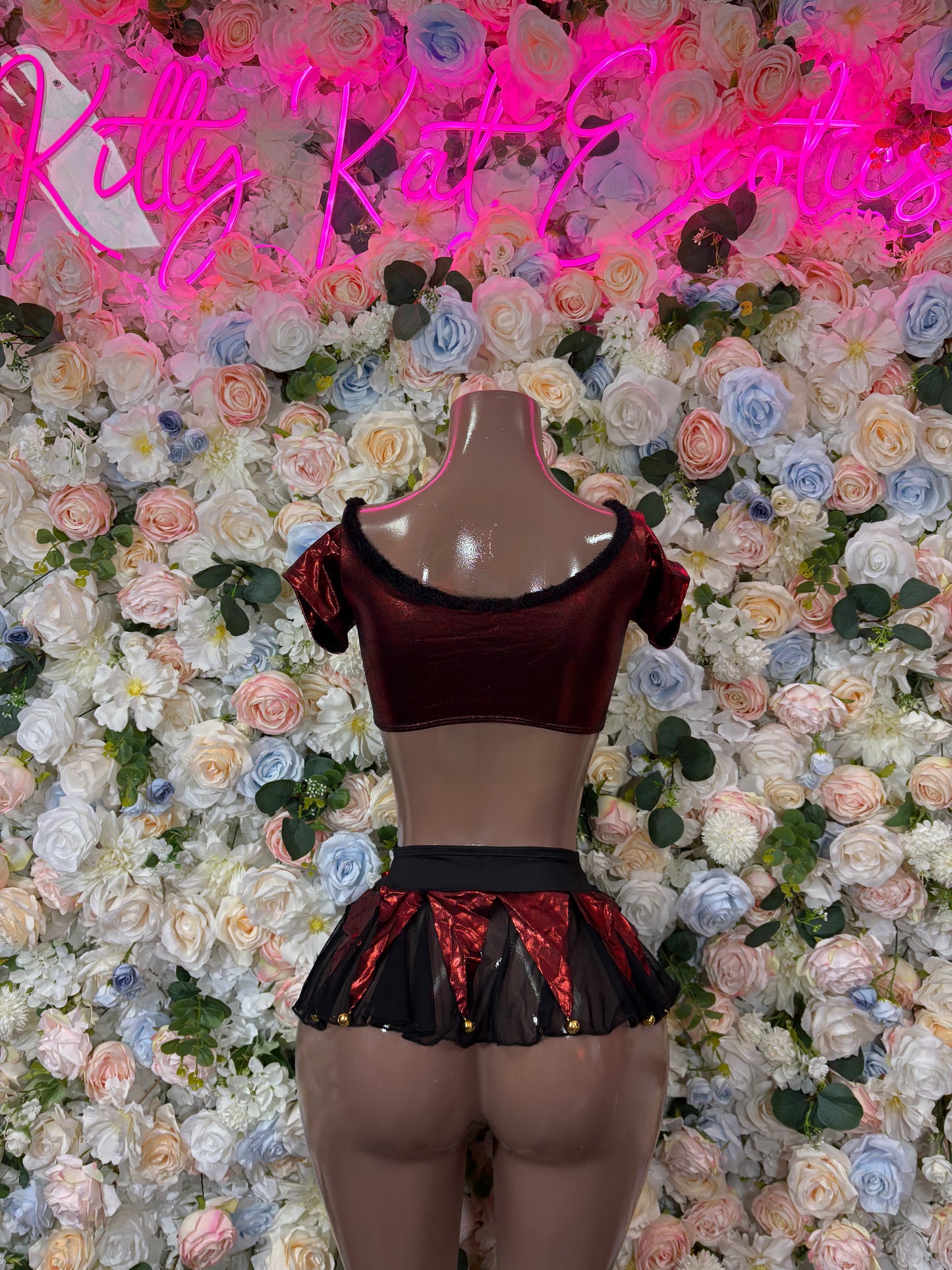 Burgundy sheer crop top and ruffled metallic mini skirt set on mannequin