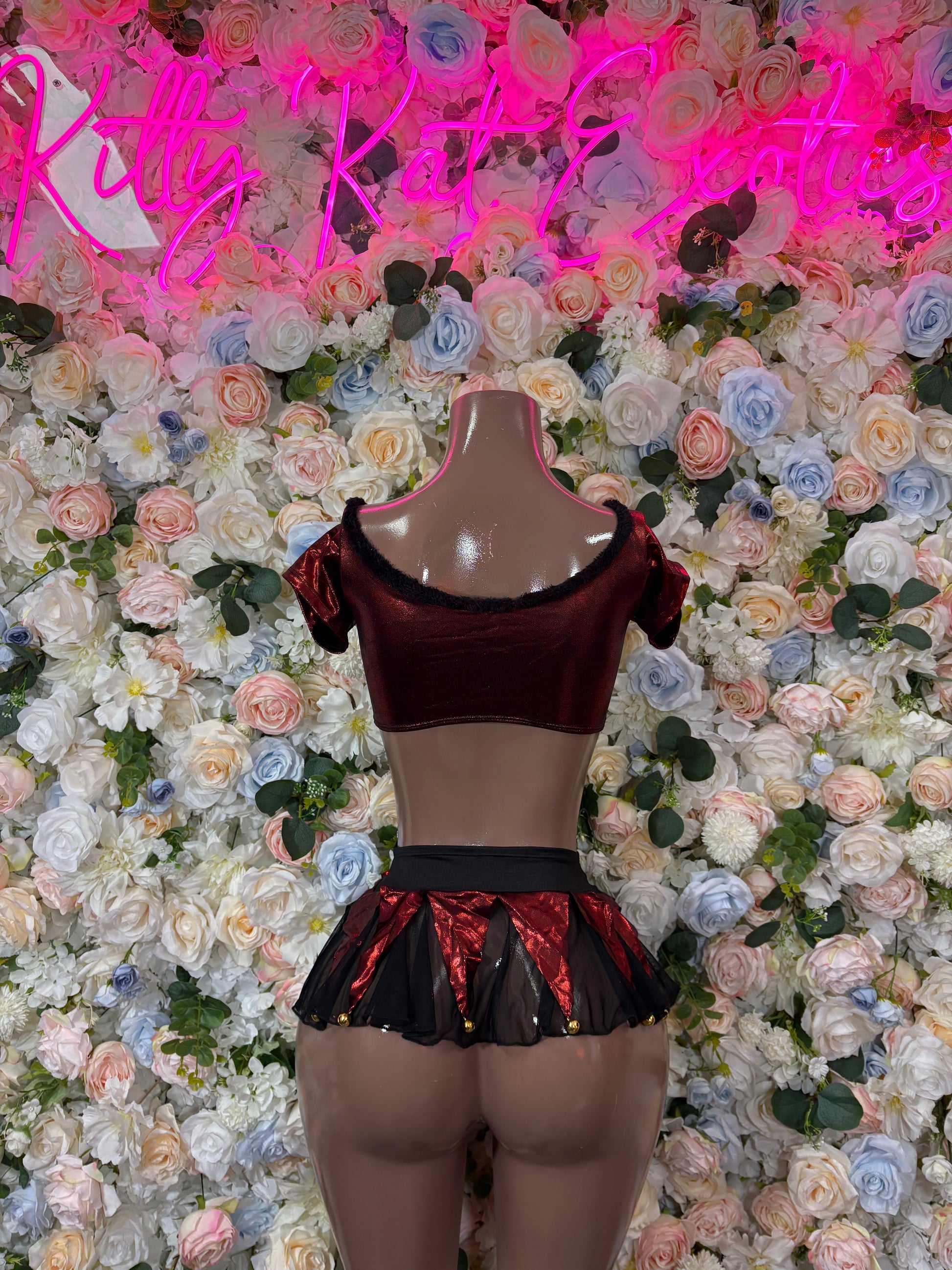 Burgundy sheer crop top and ruffled metallic mini skirt set on mannequin