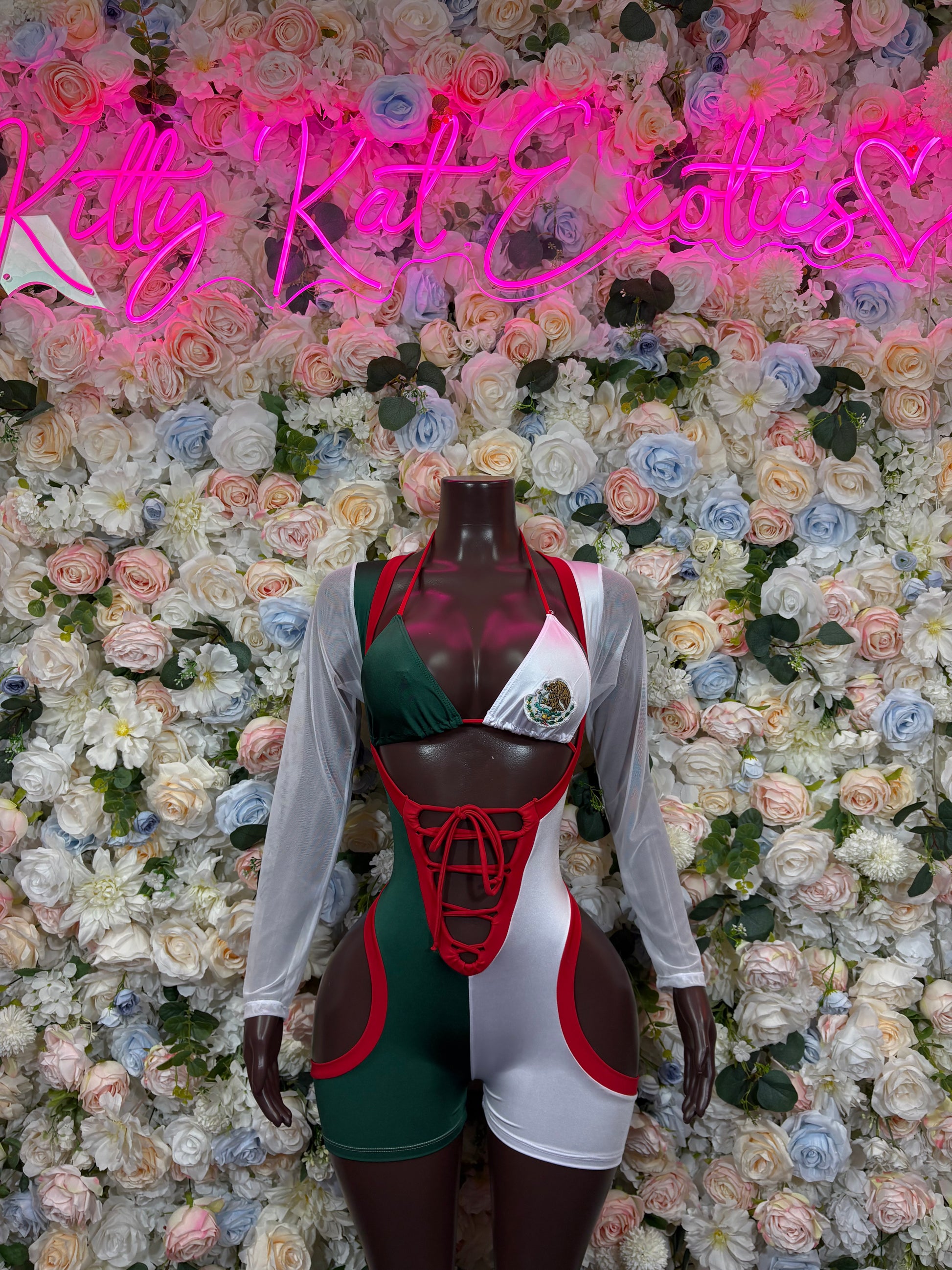 Green, red and white tie-dye bodysuit with long sleeves and red crisscross lacing