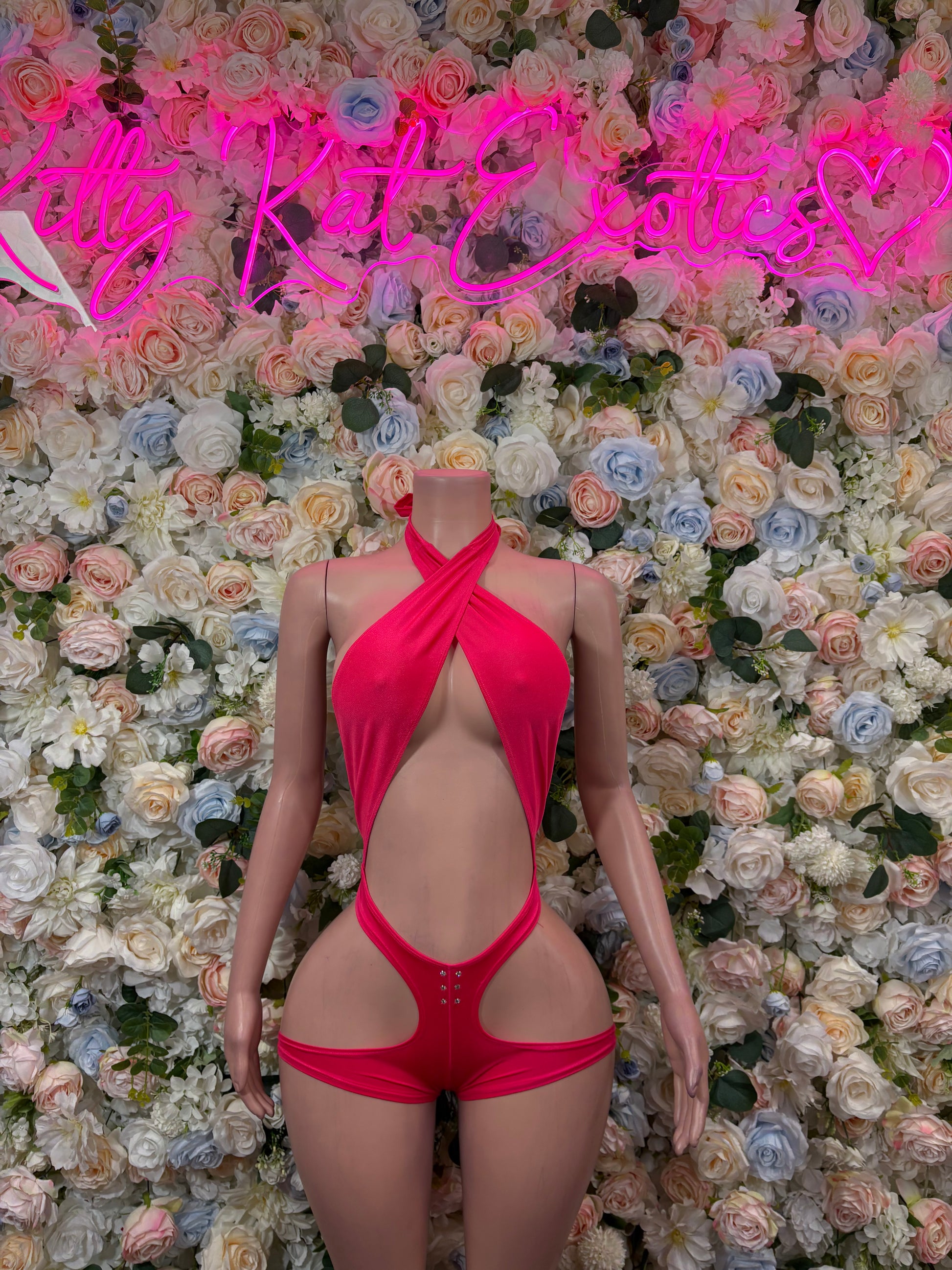 Hot pink halter wrap bodysuit with open back and high-cut thong leg