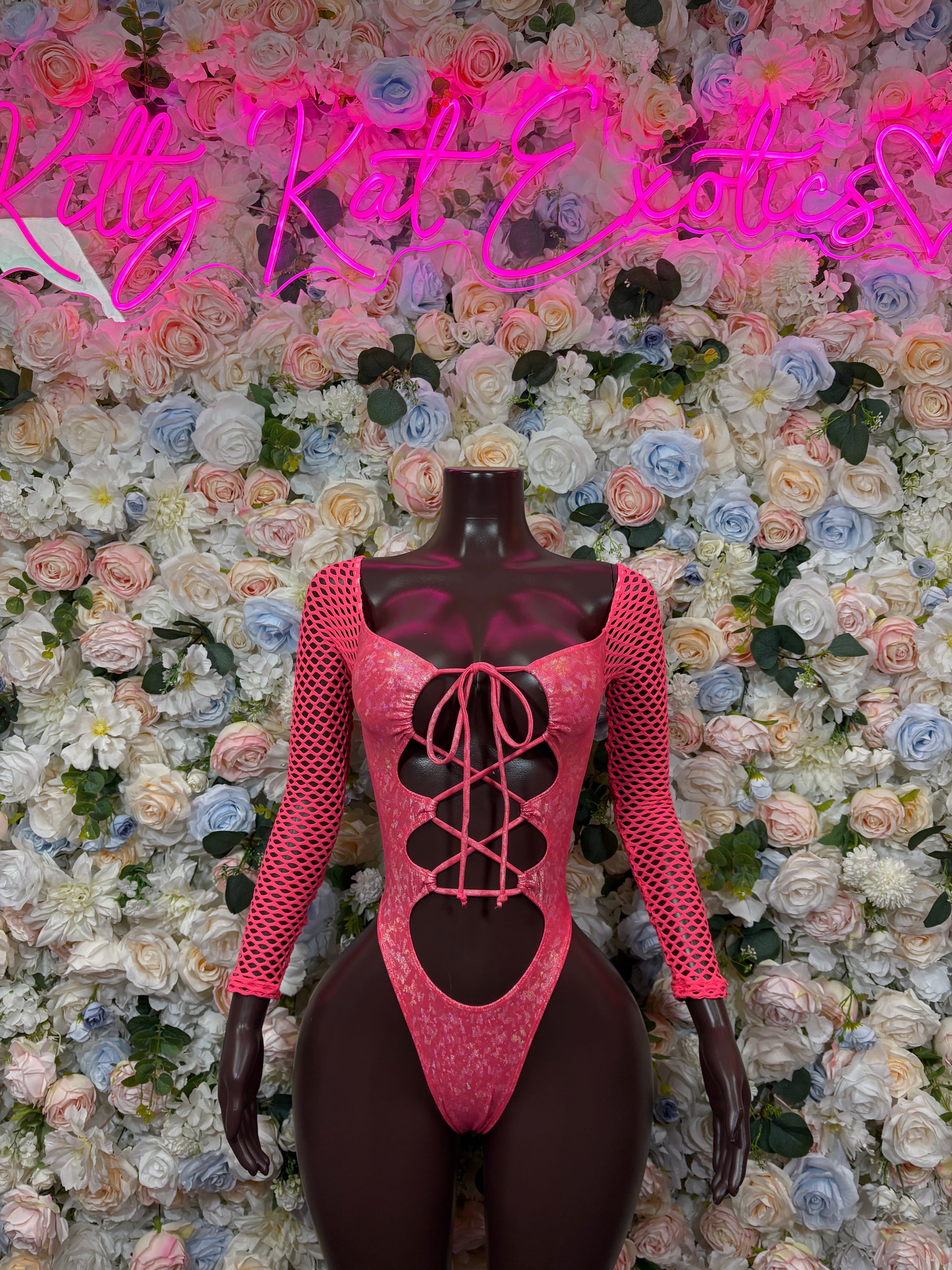 Pink crushed mesh bodysuit with long sleeves, lace-up back and front cutout