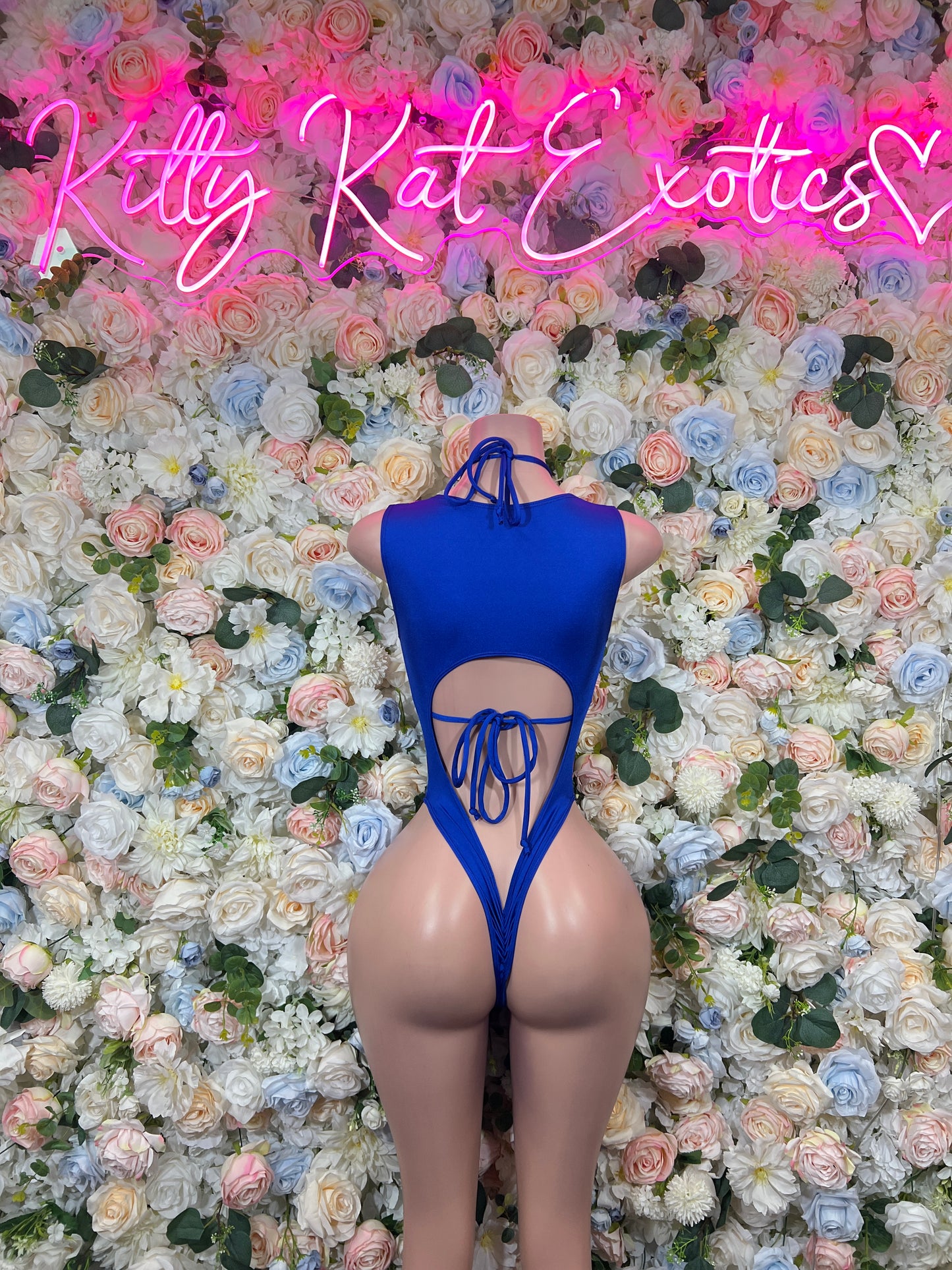 Back-view blue paint-splatter bodysuit with lace-up halter straps and open back