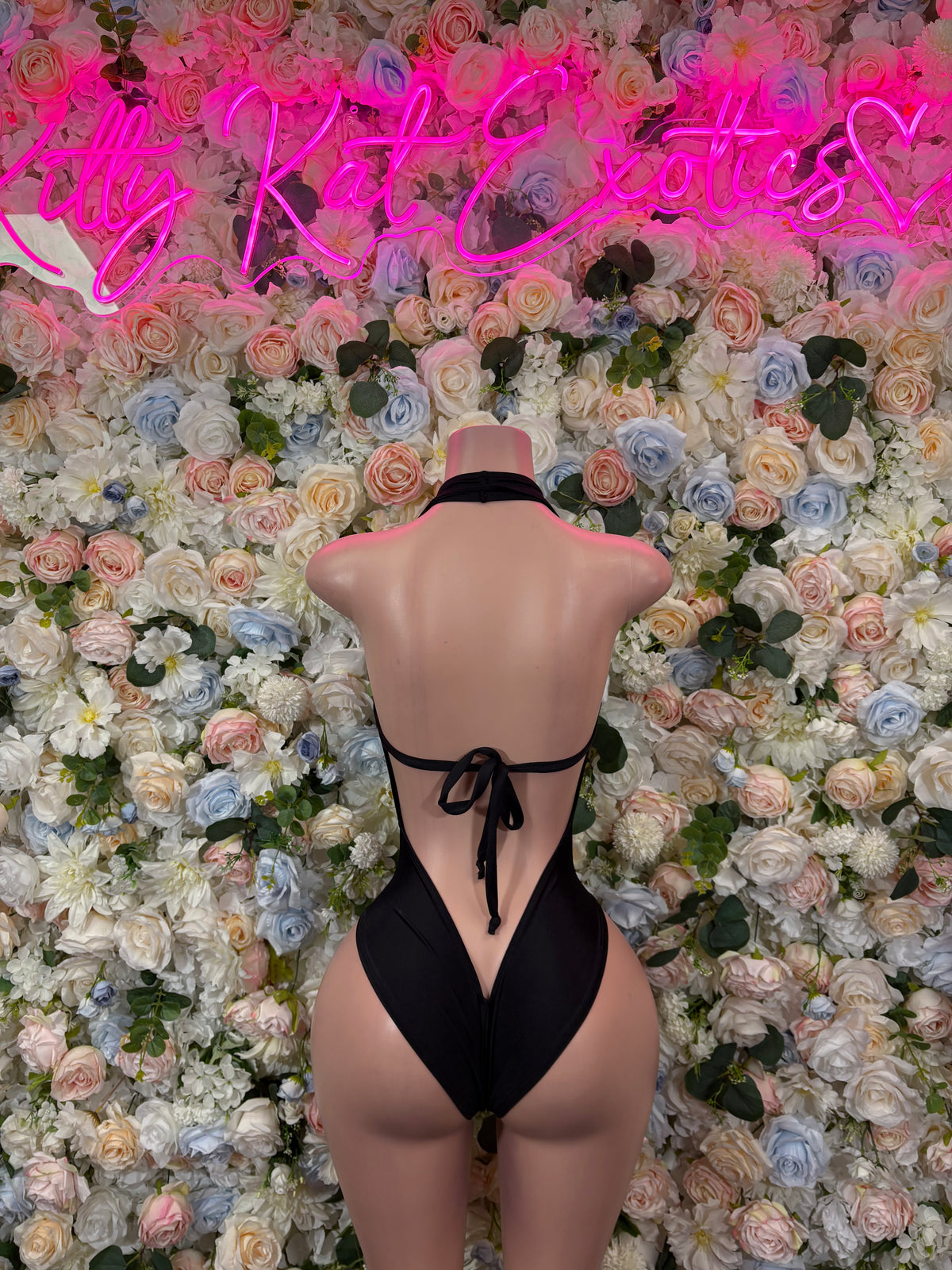 Black open-back bodysuit with high-cut leg and tie back, back view