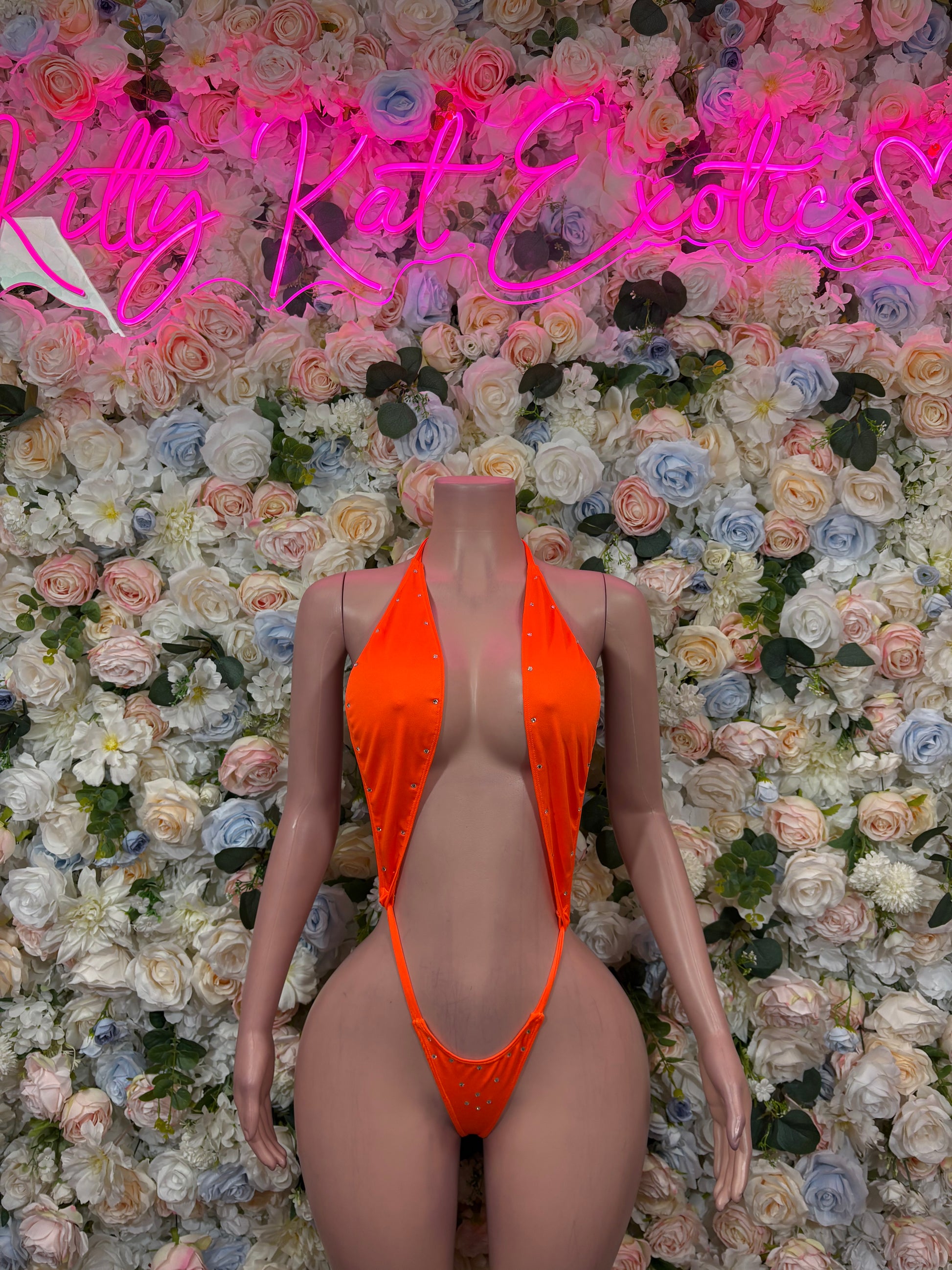 Orange one-piece bodysuit with halter neck and high-cut legs