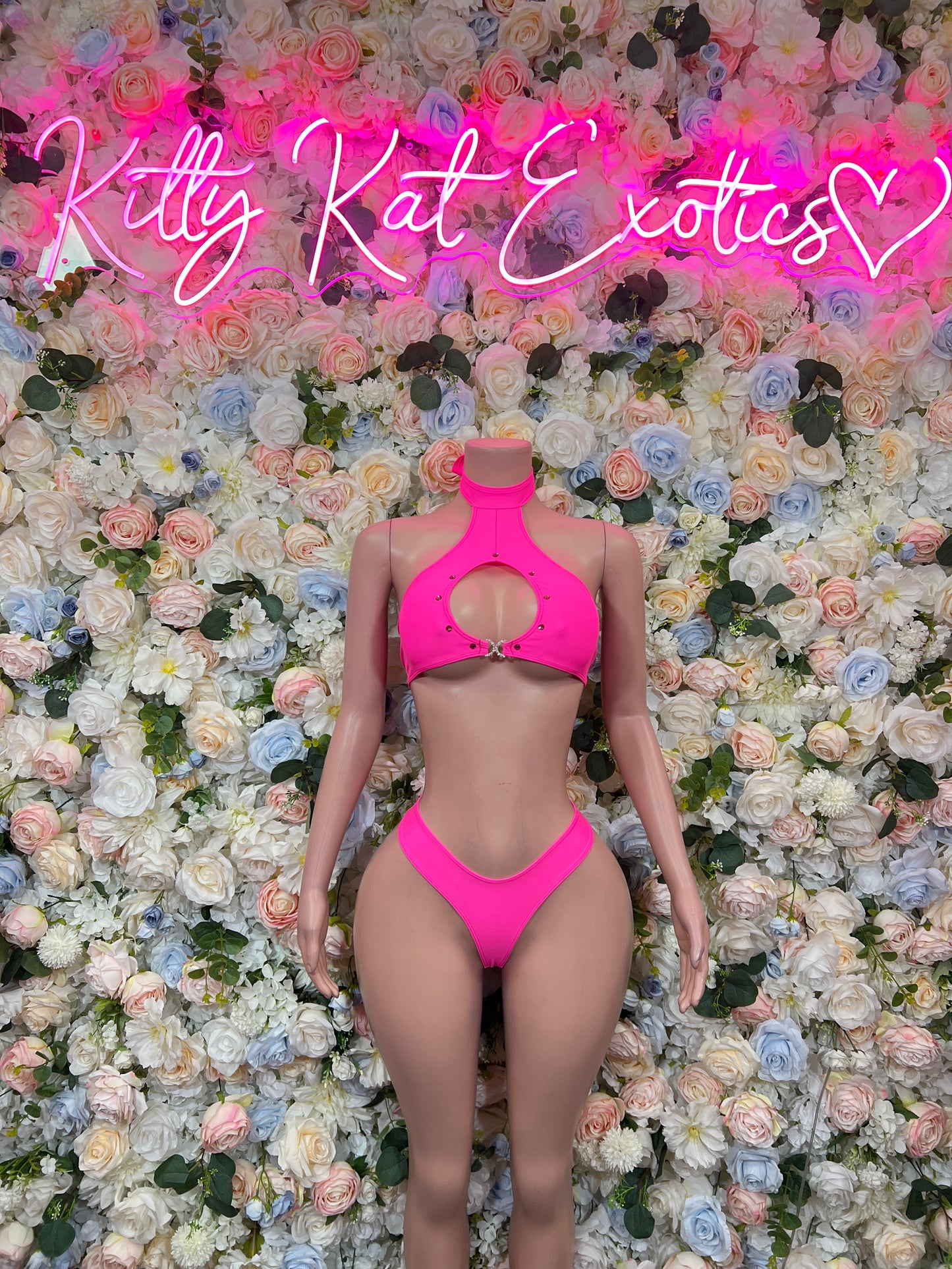 Pink halter two-piece bikini with front cutout and high-cut bottoms, front view