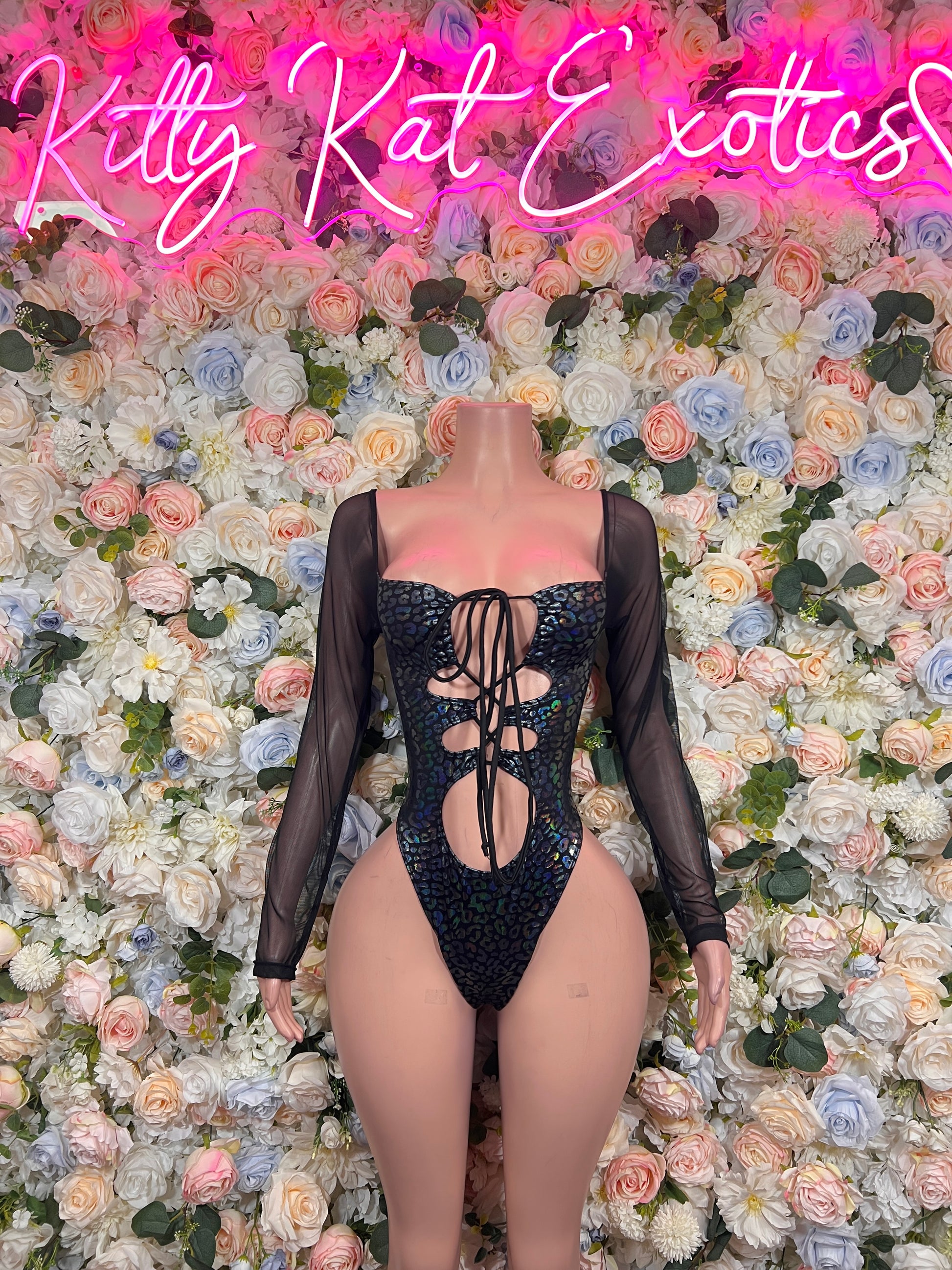 Black sheer long-sleeve bodysuit with lace-up front and cheetah-style center pattern