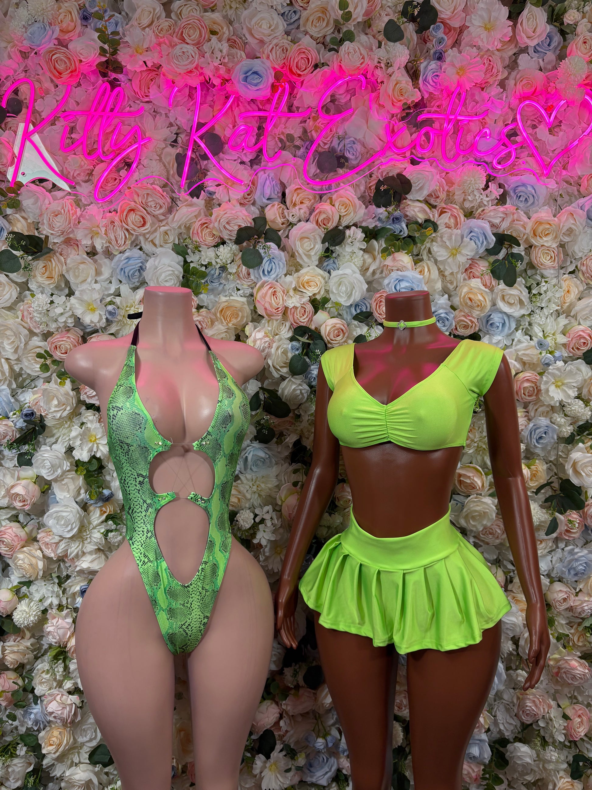 Green two-piece dancewear outfit in side view with ruched crop top and flared mini skirt