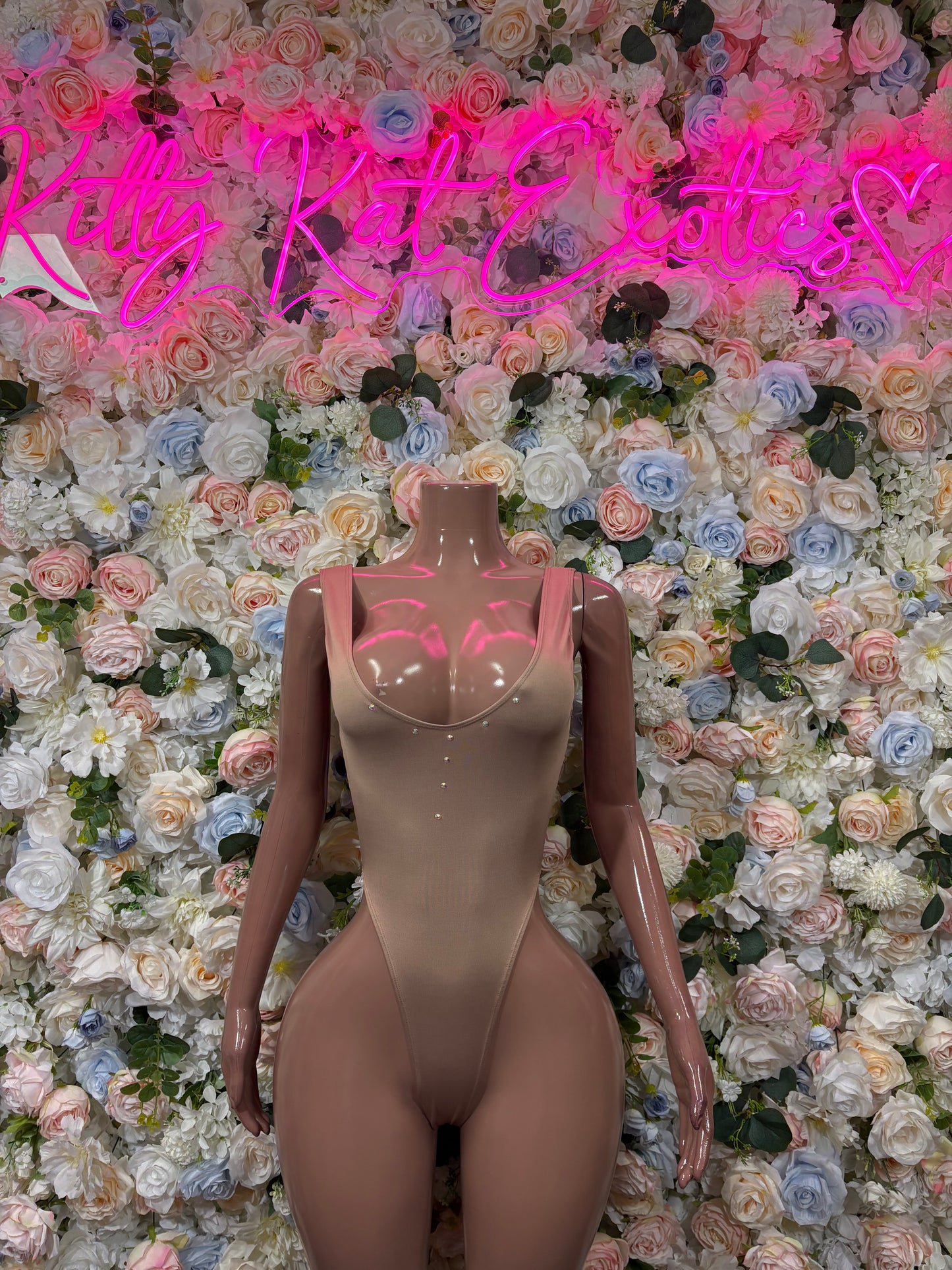 Nude beige sleeveless bodysuit, one-piece with thong-style bottom and V neckline