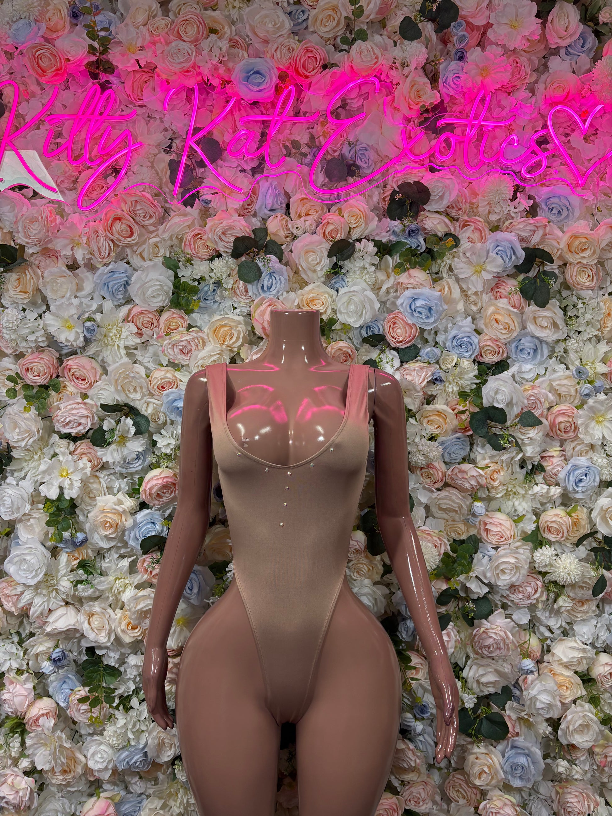 Nude beige sleeveless bodysuit, one-piece with thong-style bottom and V neckline