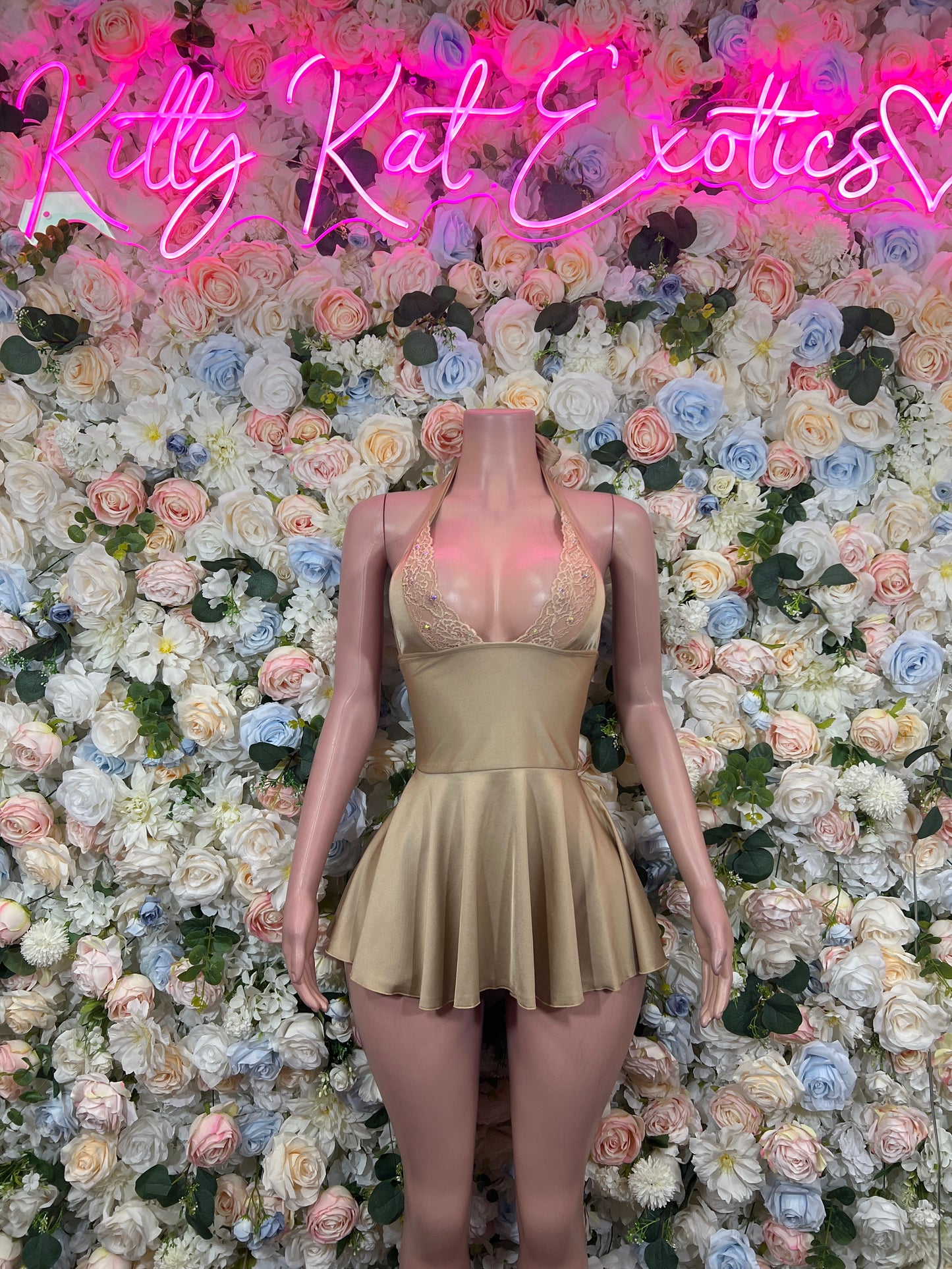 Beige fitted mini dress with deep V neckline and flared skirt
