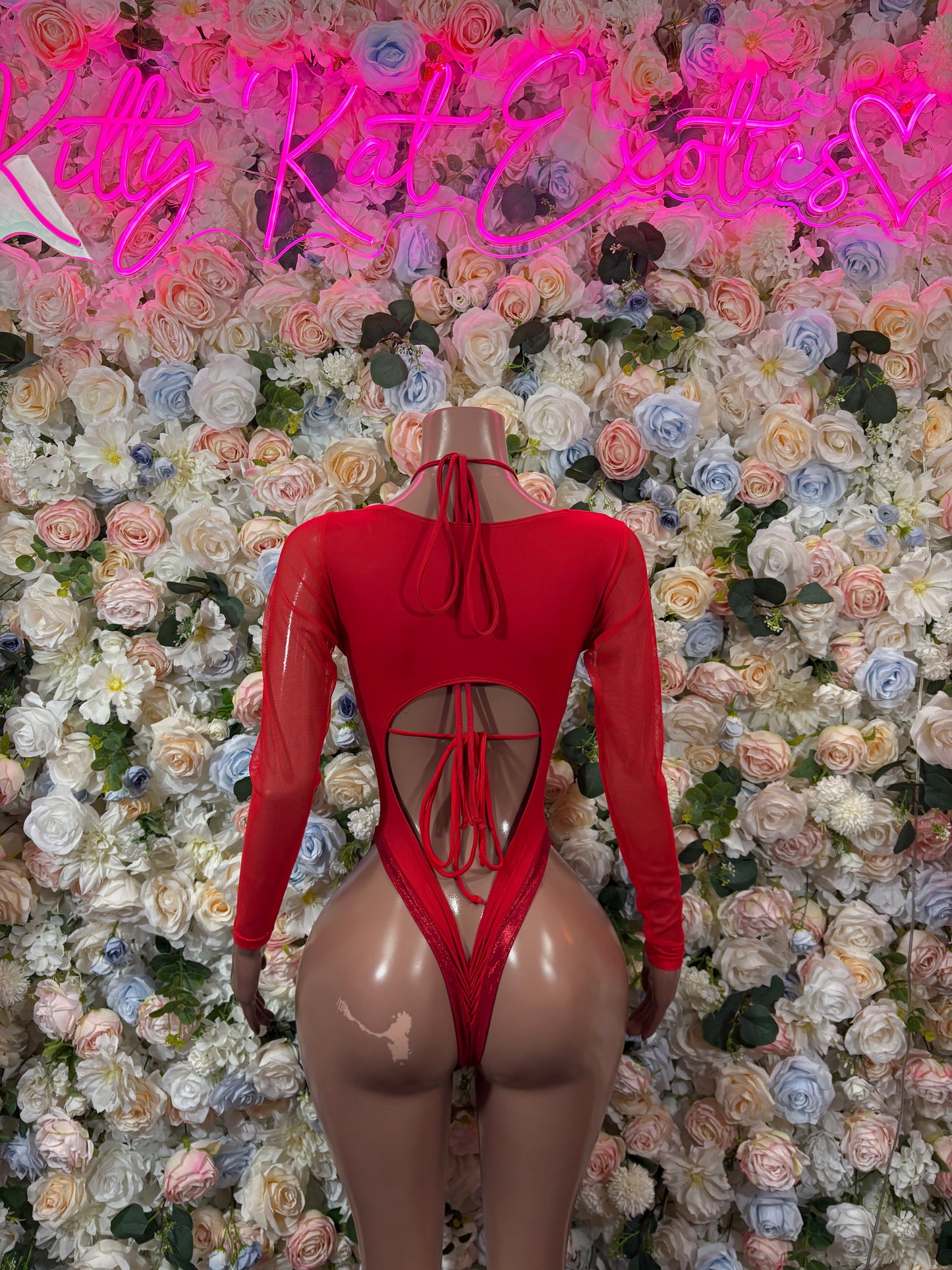 Red long-sleeve bodysuit with heart detail, high-cut leg and crisscross lace front