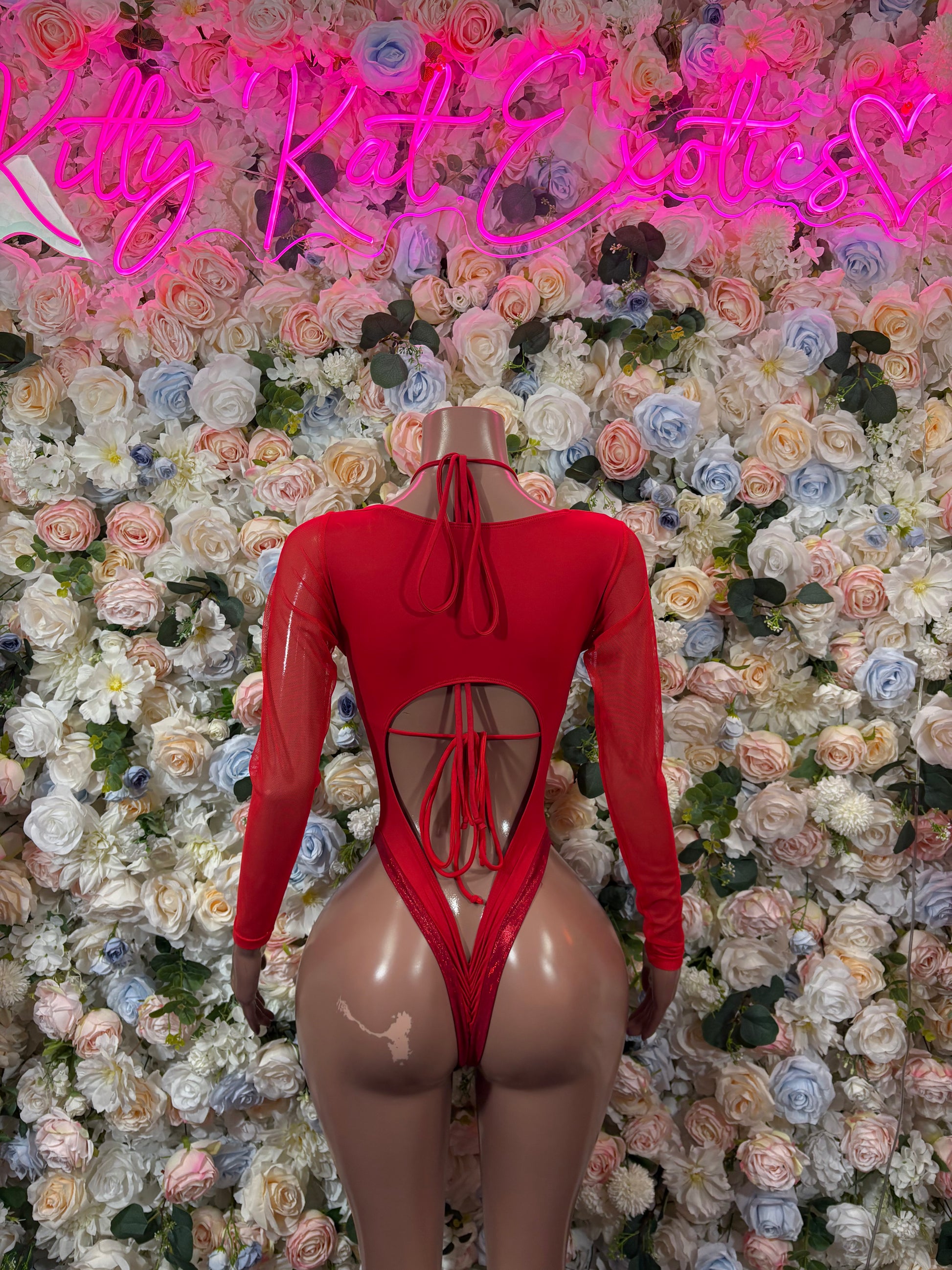 Red long-sleeve bodysuit with heart detail, high-cut leg and crisscross lace front