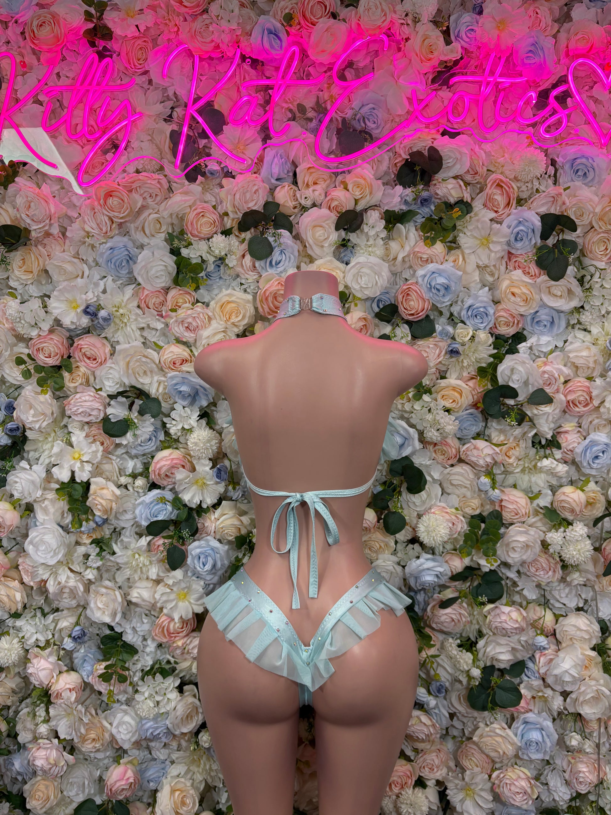 Light blue two-piece rave outfit, strappy back and tie thong bottoms on mannequin