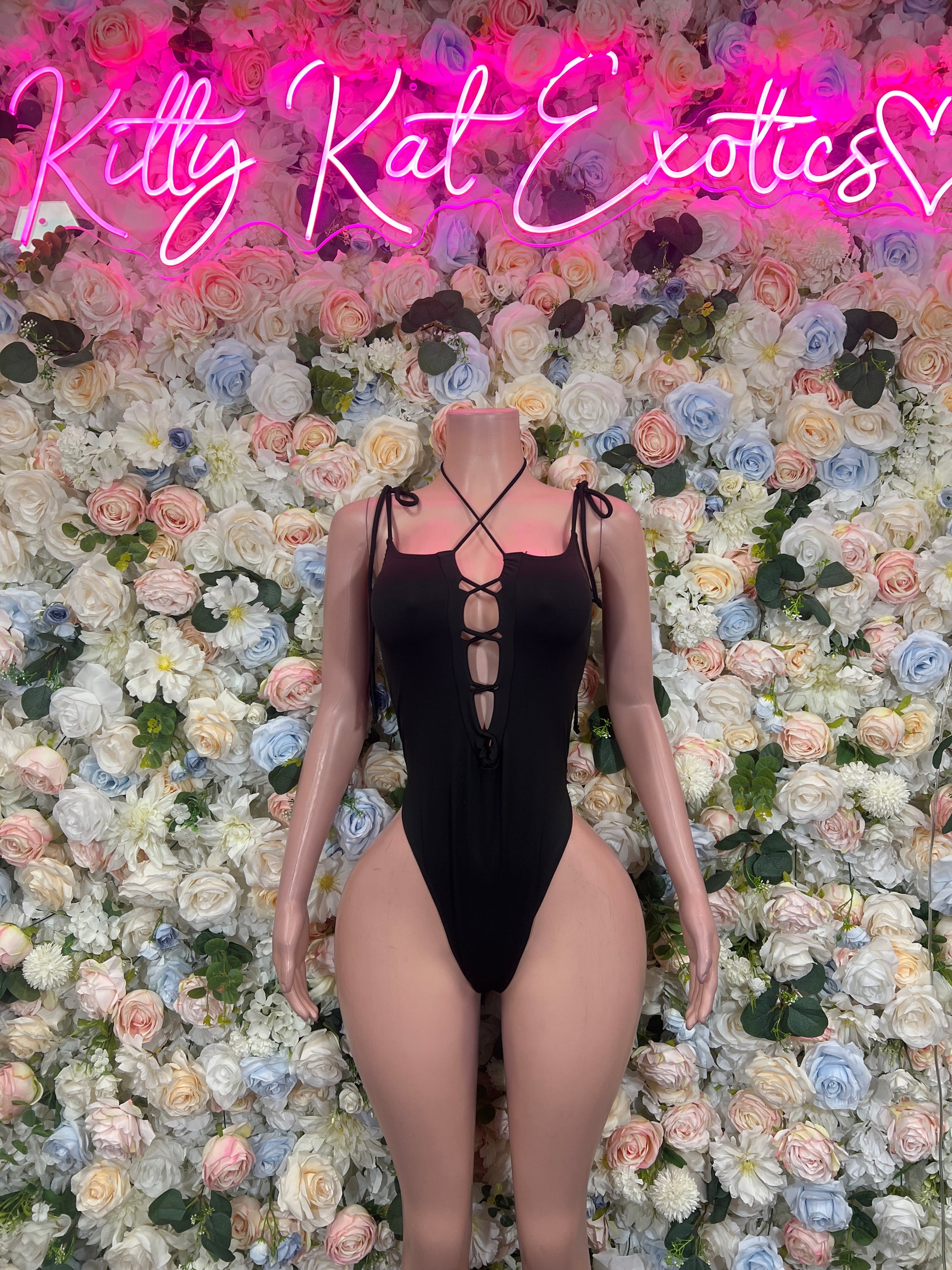 Black strappy bodysuit with cutout front and crisscross neckline