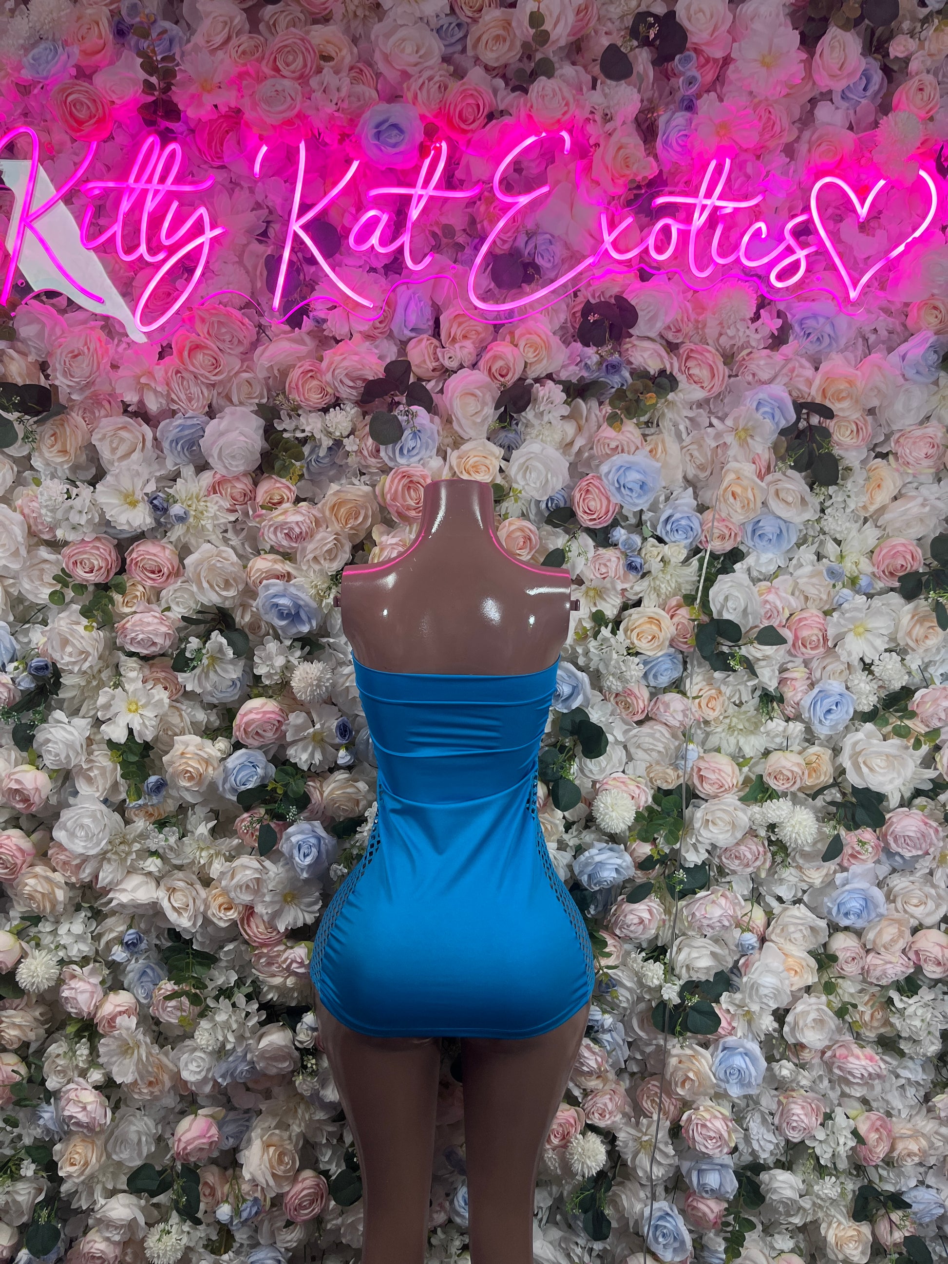 Blue one-piece dress on mannequin, strapless fitted mini, open back