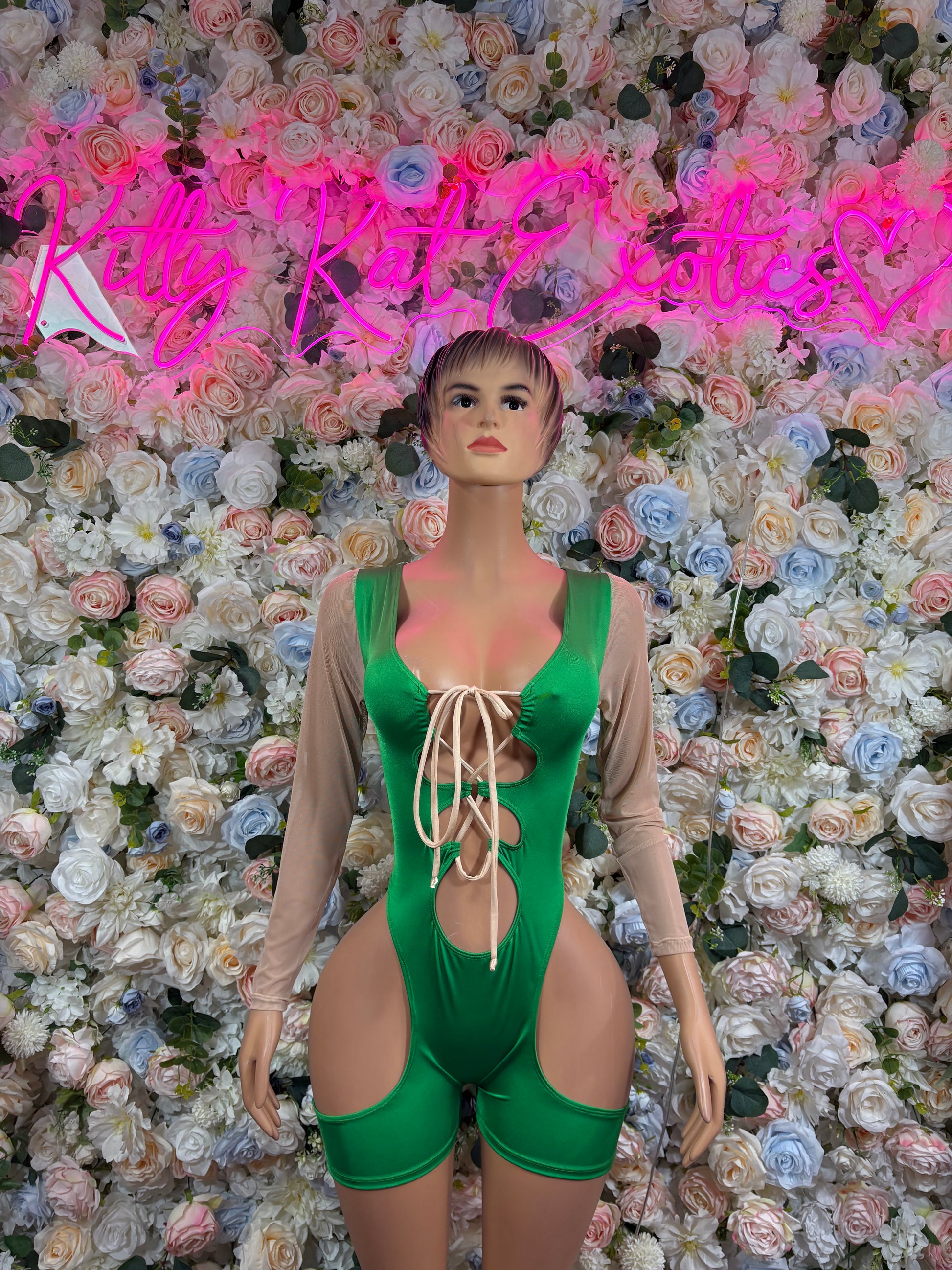 Green lace-up bodysuit with deep V neckline and cutout waist, short legs