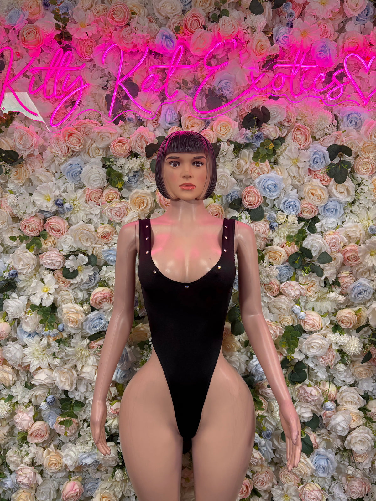 Black one-piece bodysuit with V-neck, thin straps, and high-cut leg