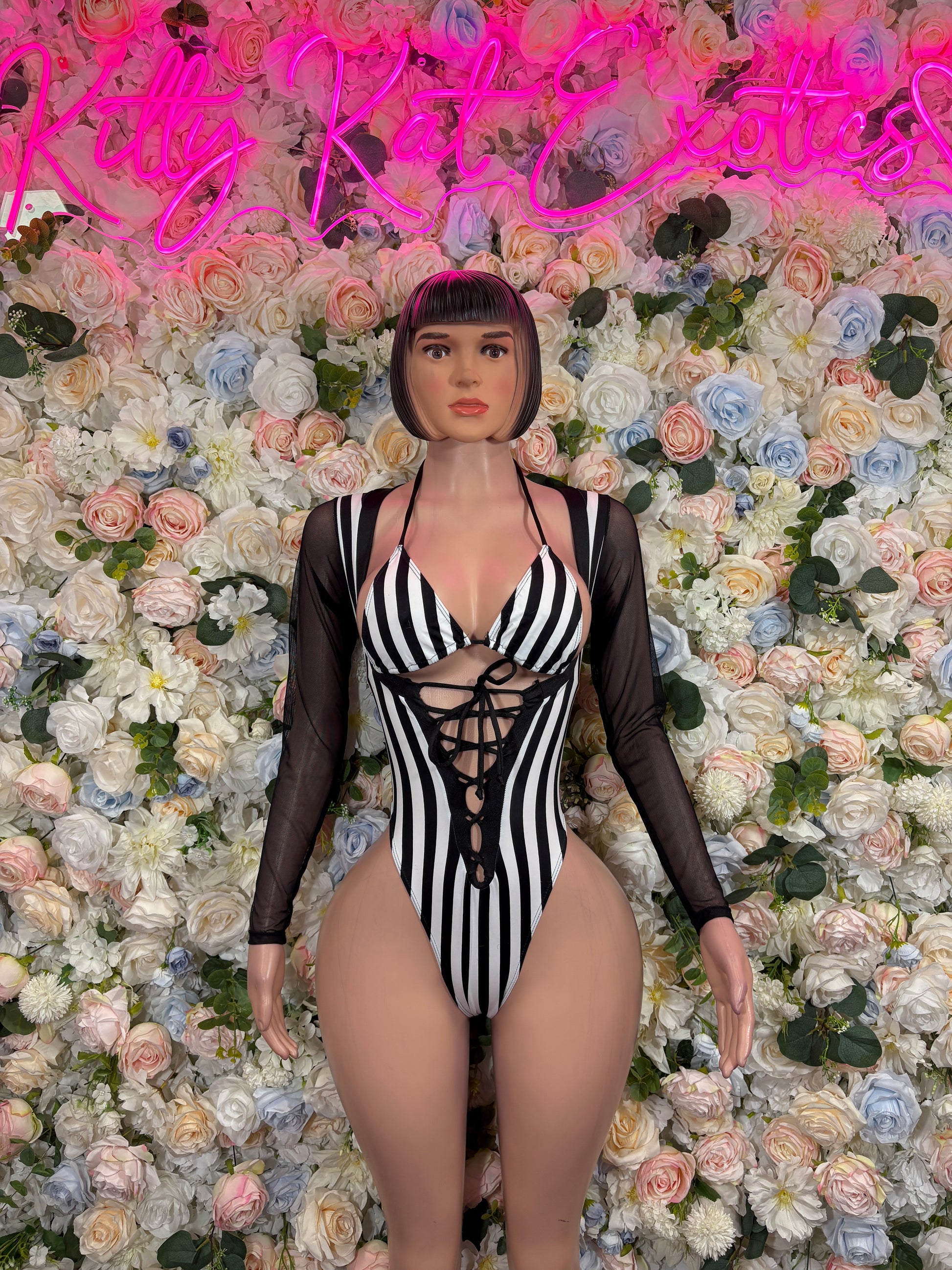 Striped black bodysuit with long sleeves, V-neck, and lace-up center front