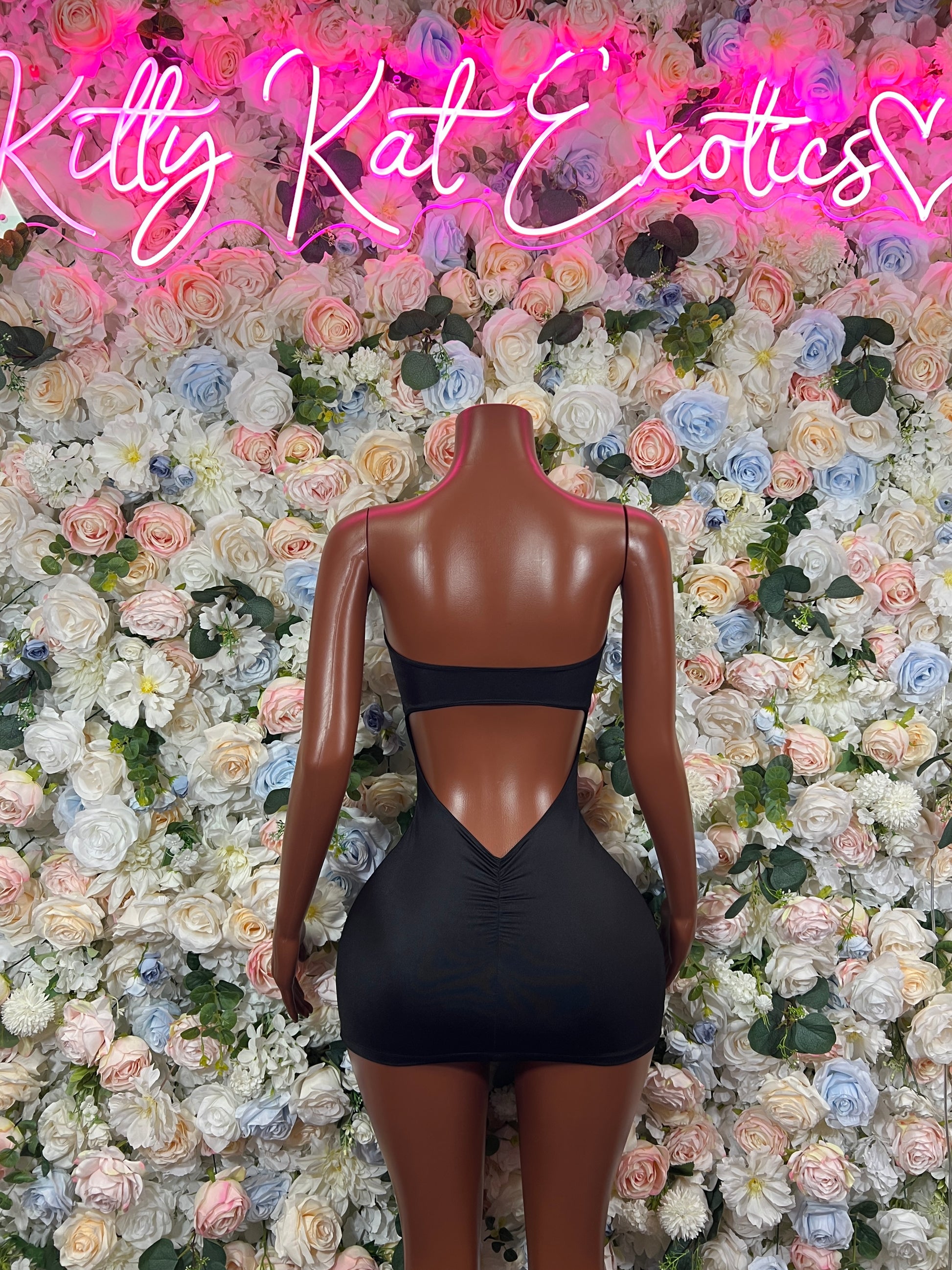 Black mini dress with open back and V-shaped back cutout