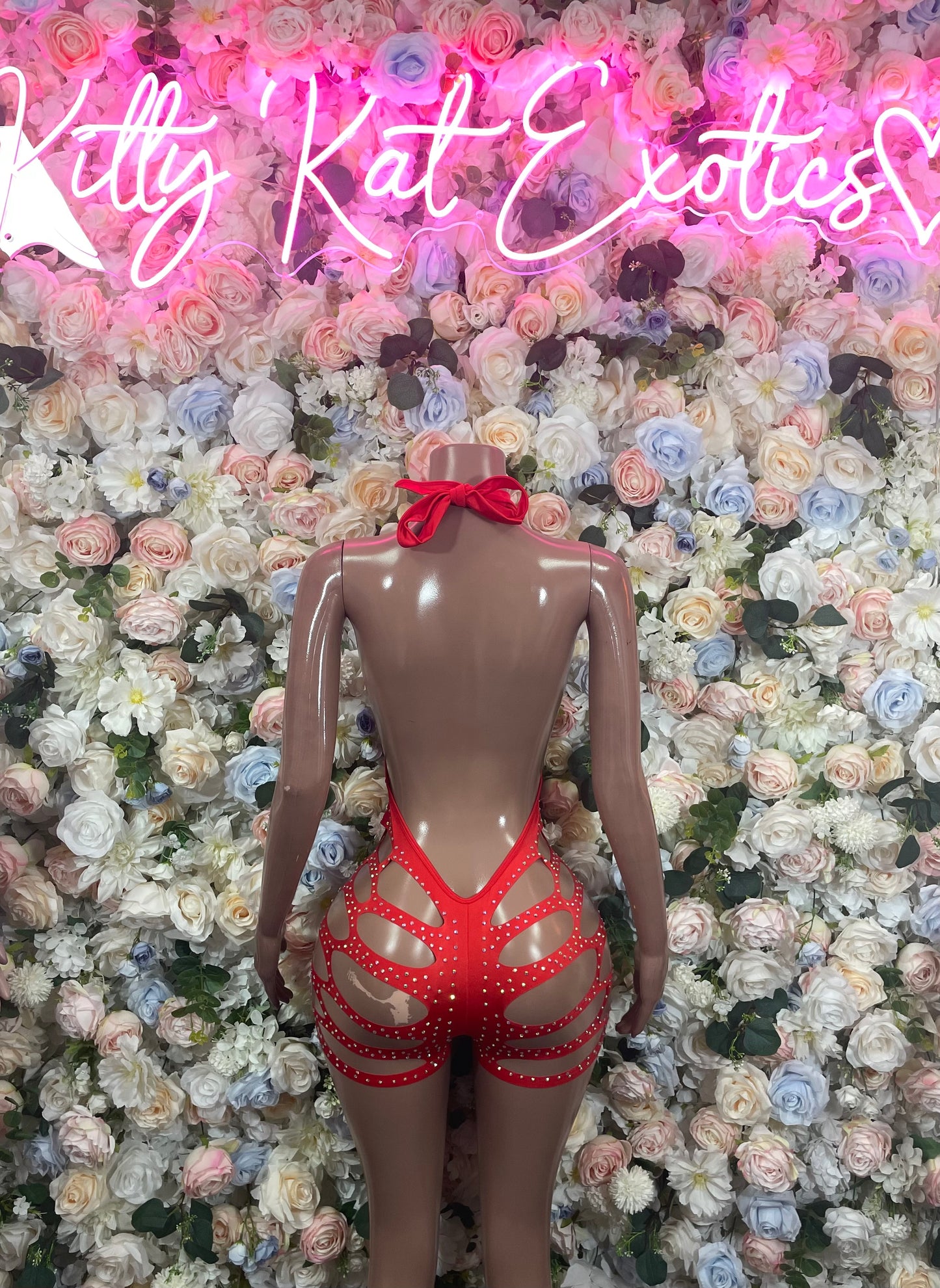 Red rhinestone bodysuit back view with crisscross straps and bow