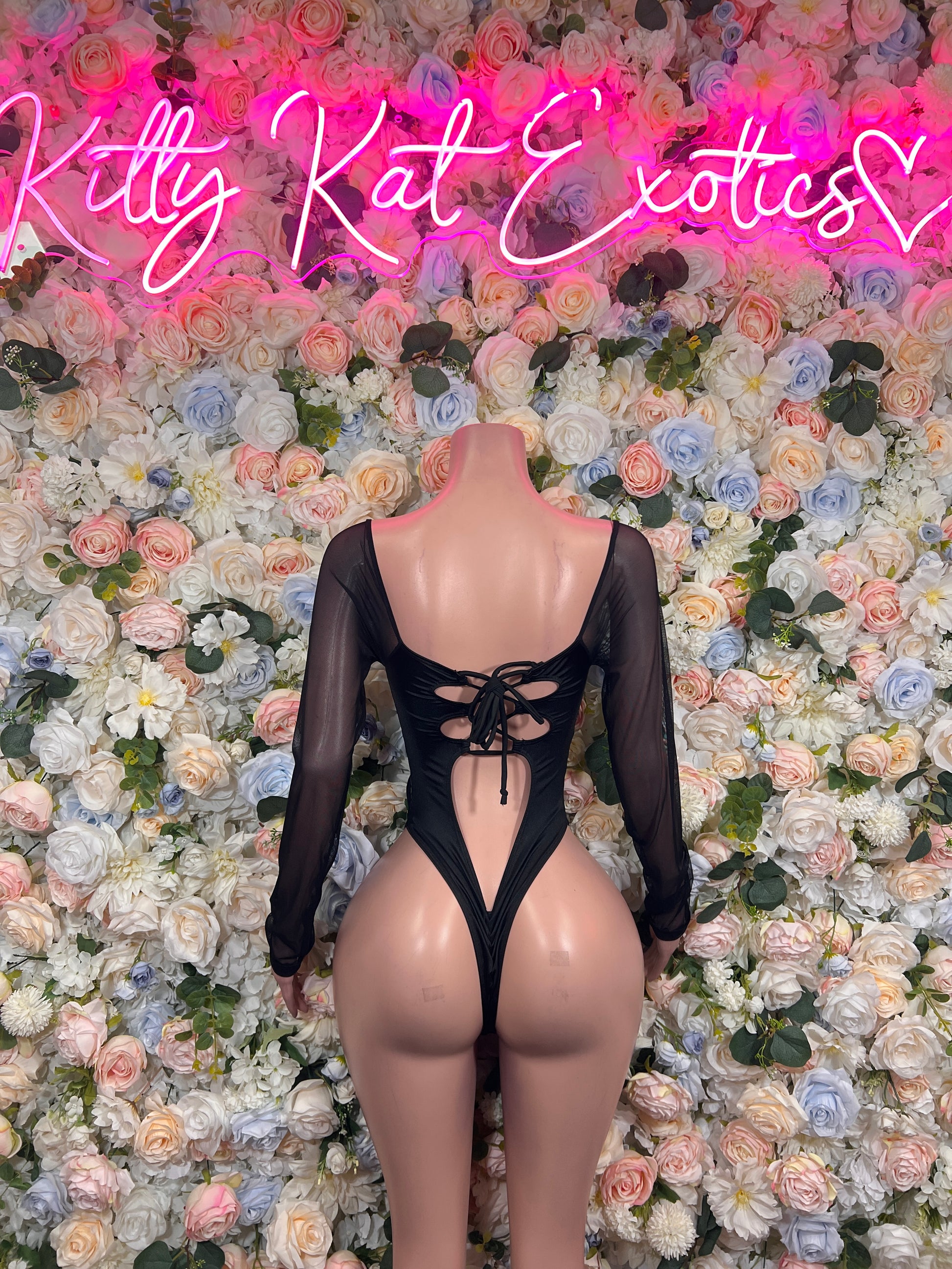 Black sheer long-sleeve bodysuit with lace-up front and open back detail