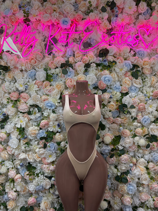Tan bodysuit one-piece on mannequin, high-cut legs and scoop front