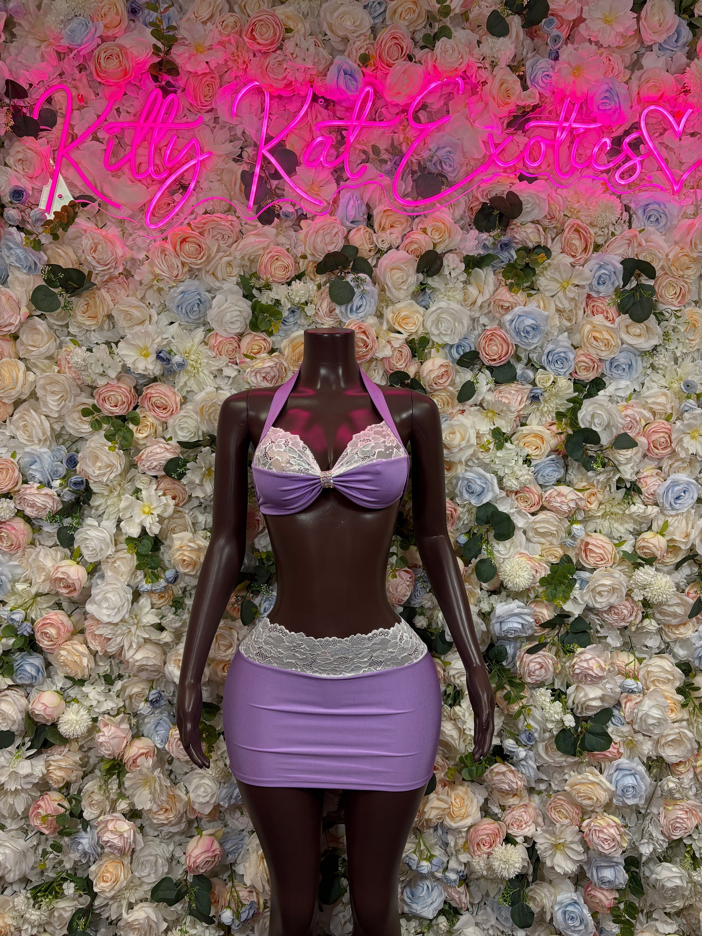Purple satin two-piece lingerie set with lace-trim bra top and mini skirt