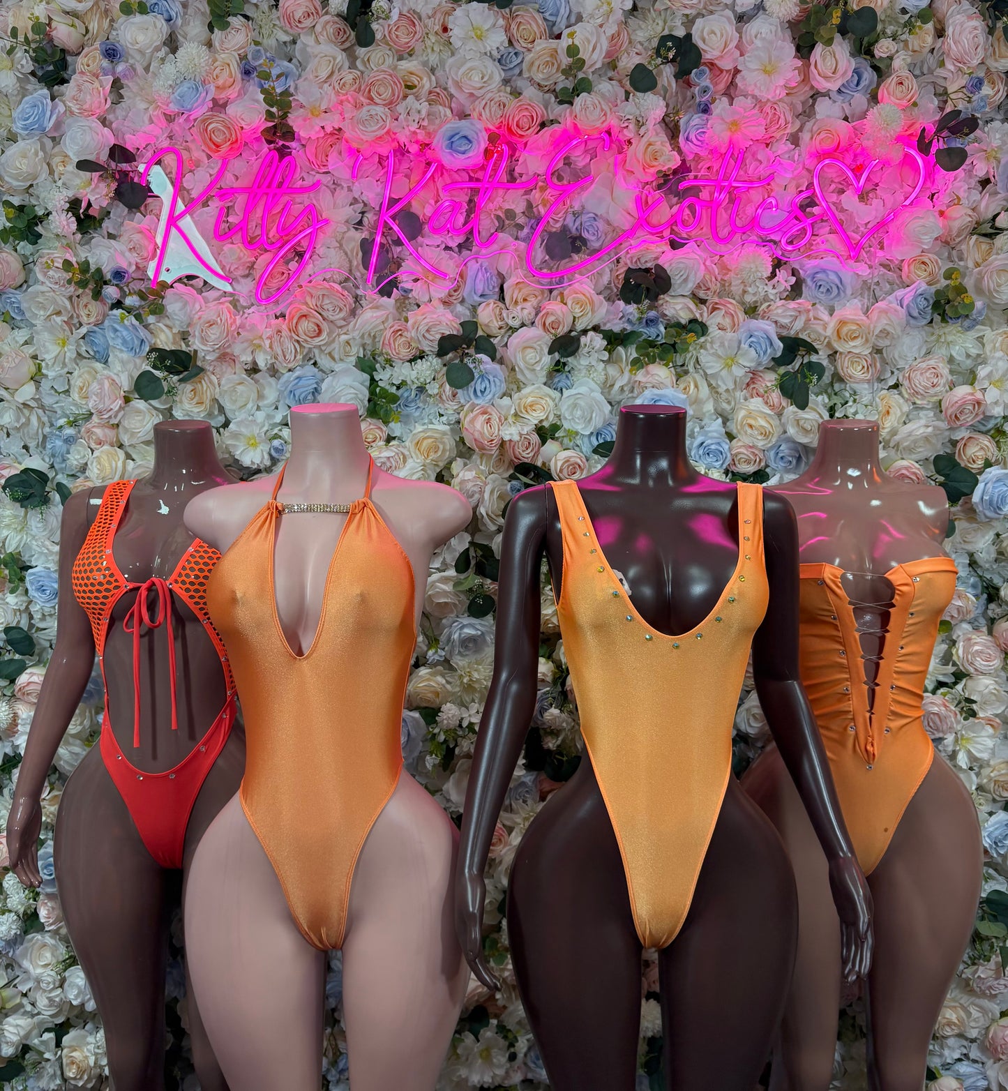 Orange one-piece bodysuit on mannequins, plunging V front and thin straps