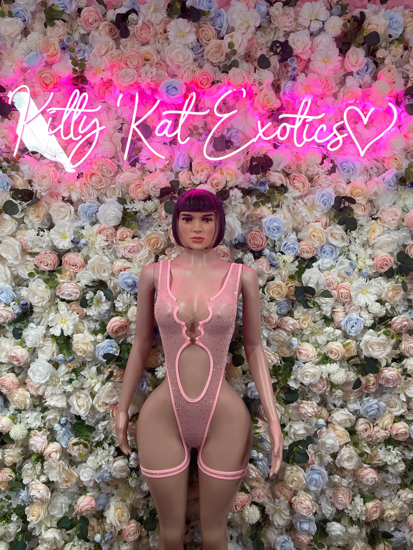 Pink rhinestone bodysuit with cutout front and garter-style straps