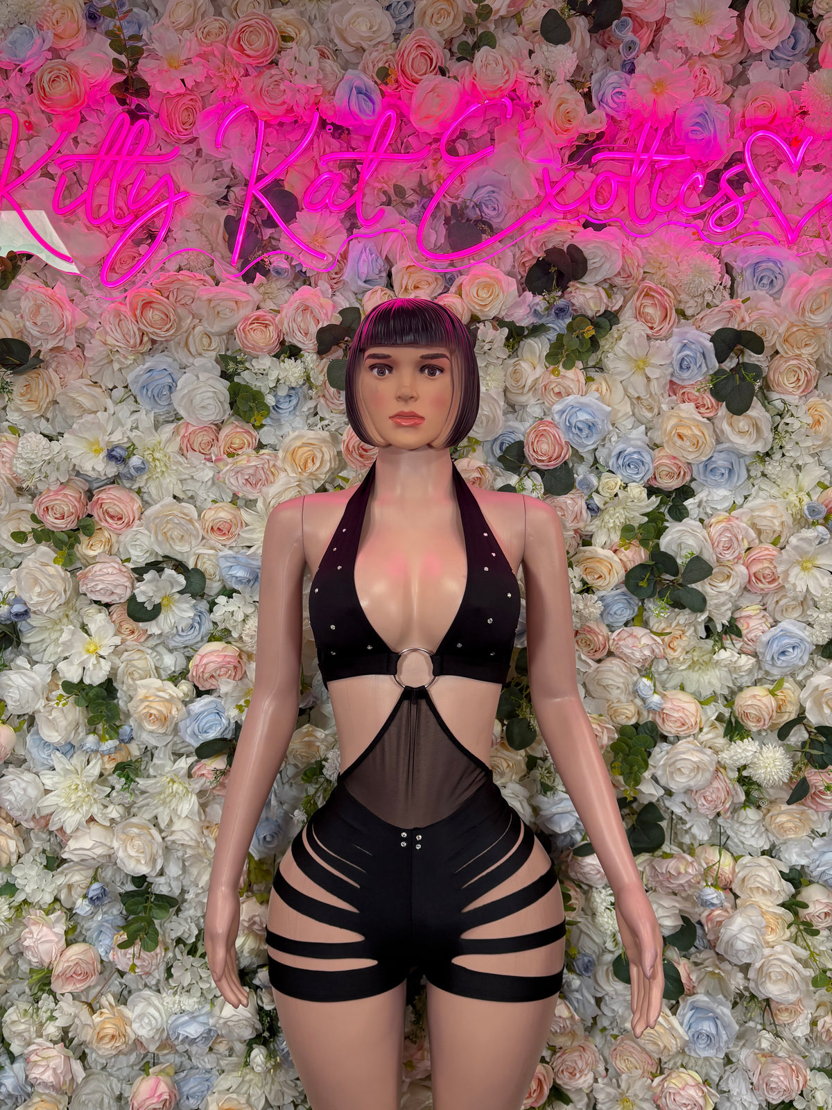 Black halter bodysuit with deep V neckline, chest clasp, and thigh cutouts