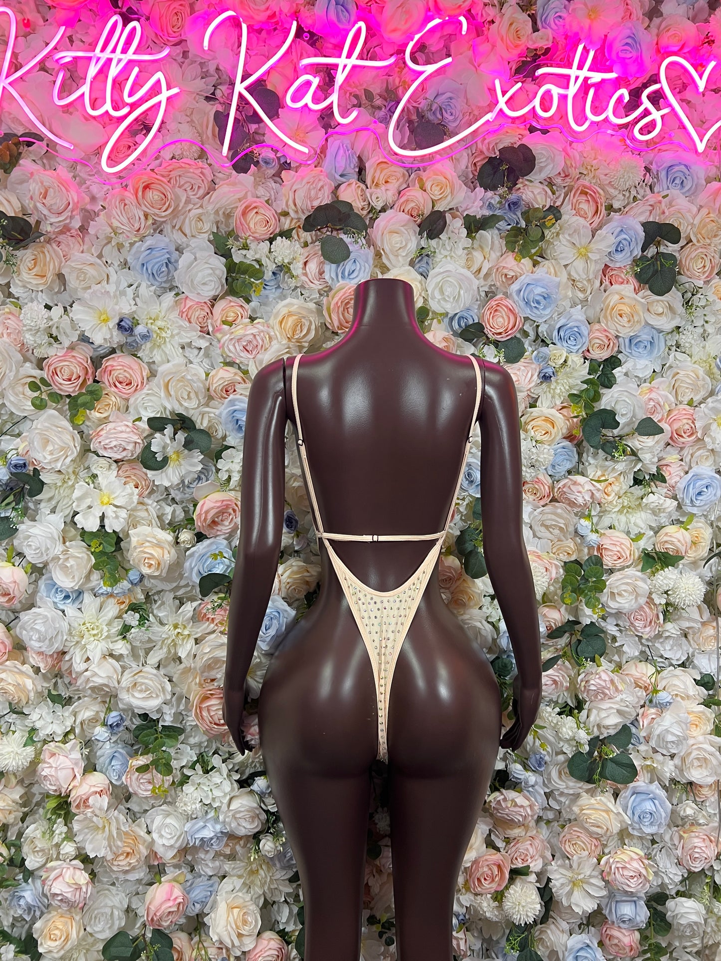 Nude rhinestone one-piece bodysuit with narrow shoulder straps and V-cut back