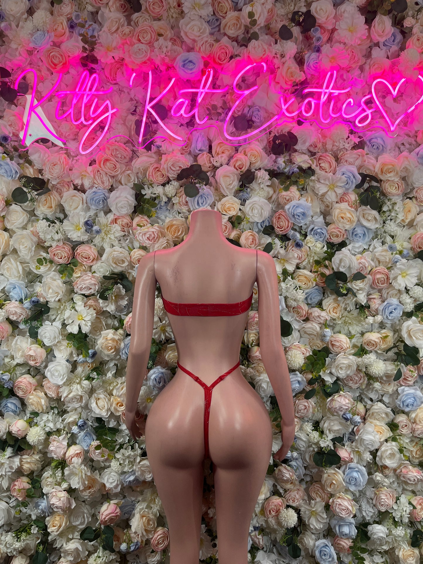 Red one-piece bodysuit with back cutout and crisscross spaghetti straps