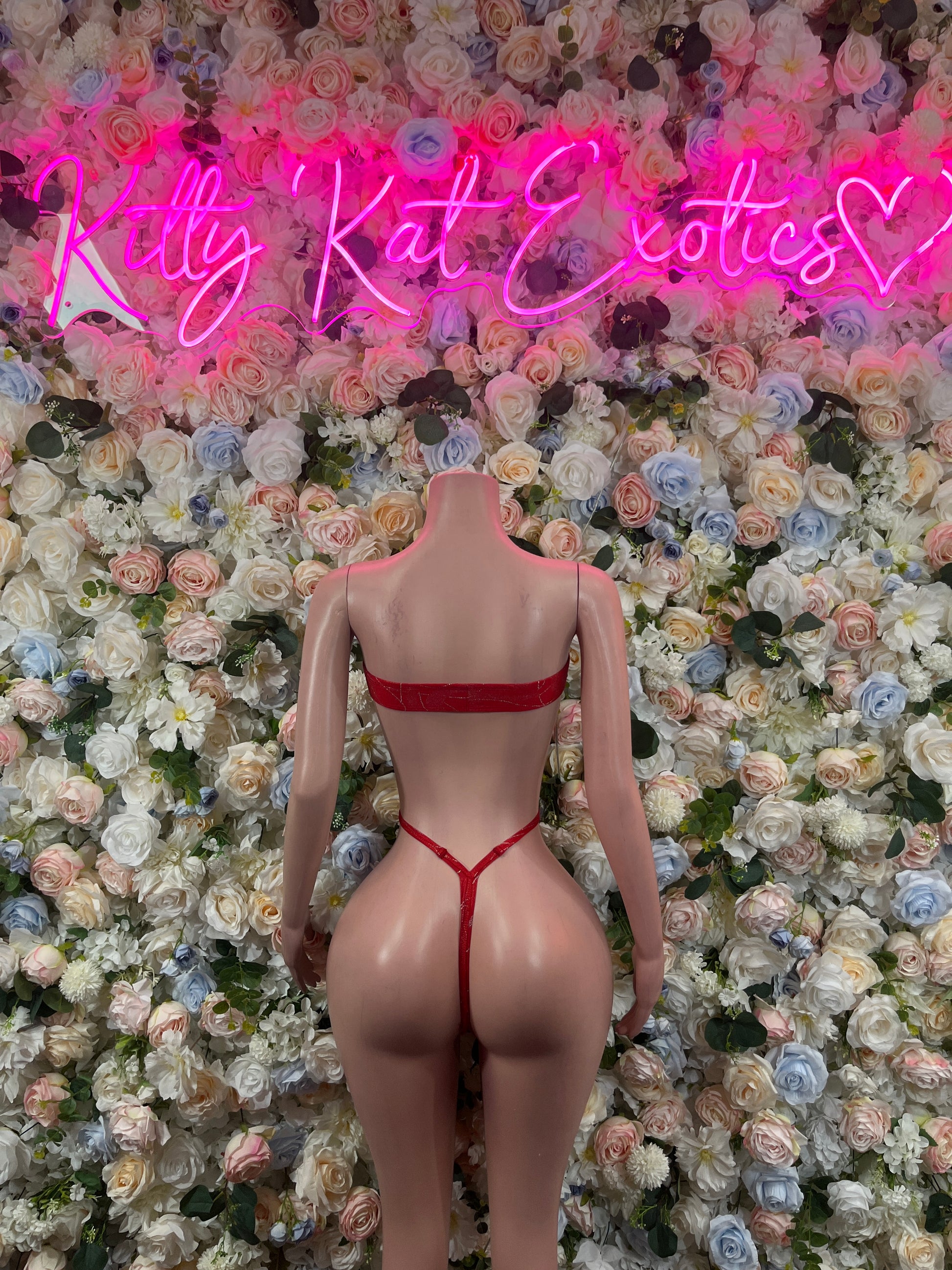 Red one-piece bodysuit with back cutout and crisscross spaghetti straps