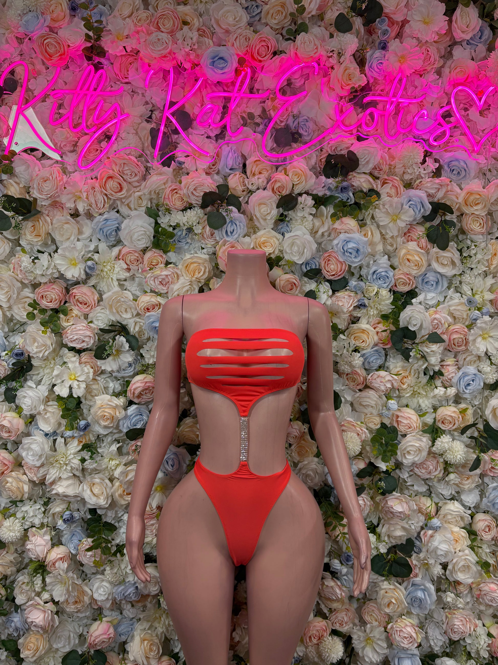 Orange one-piece bodysuit with high-cut legs and strappy back cutouts