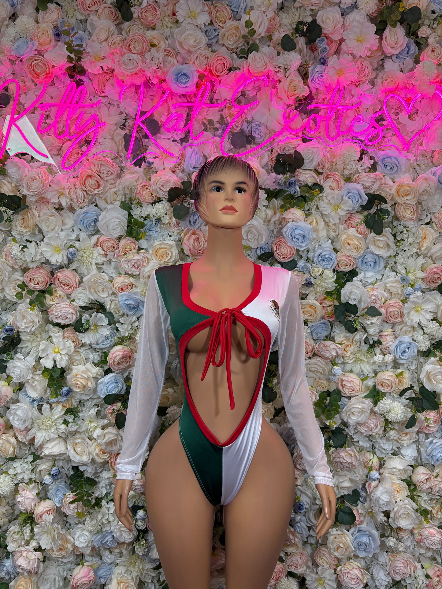 Women’s flag-style bodysuit with long sleeves, red and green panels, front tie neckline