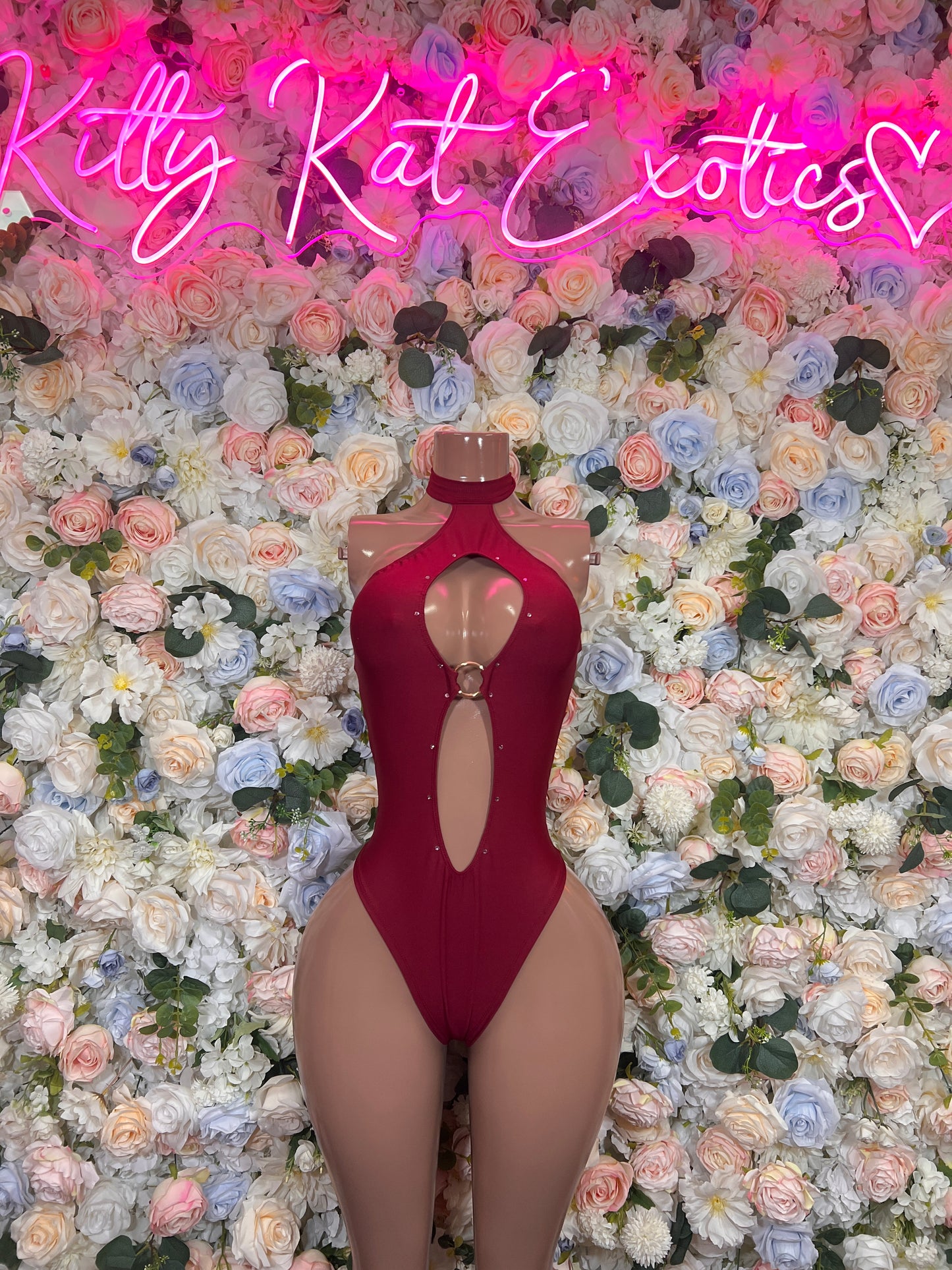 Burgundy one-piece bodysuit with halter neck, front cutout, and high-cut leg