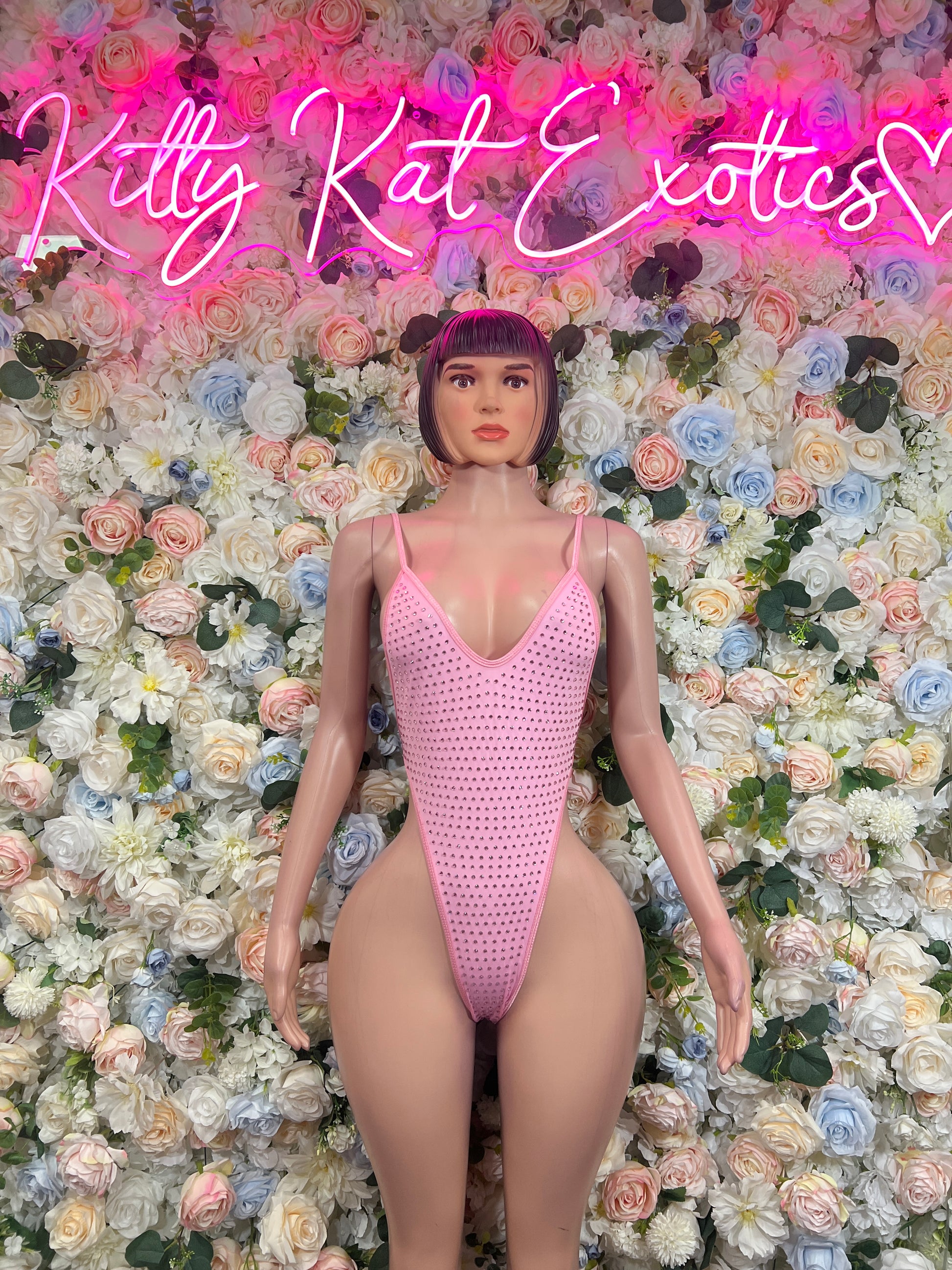 Pink rhinestone bodysuit with V-neck and single-piece thong bottom